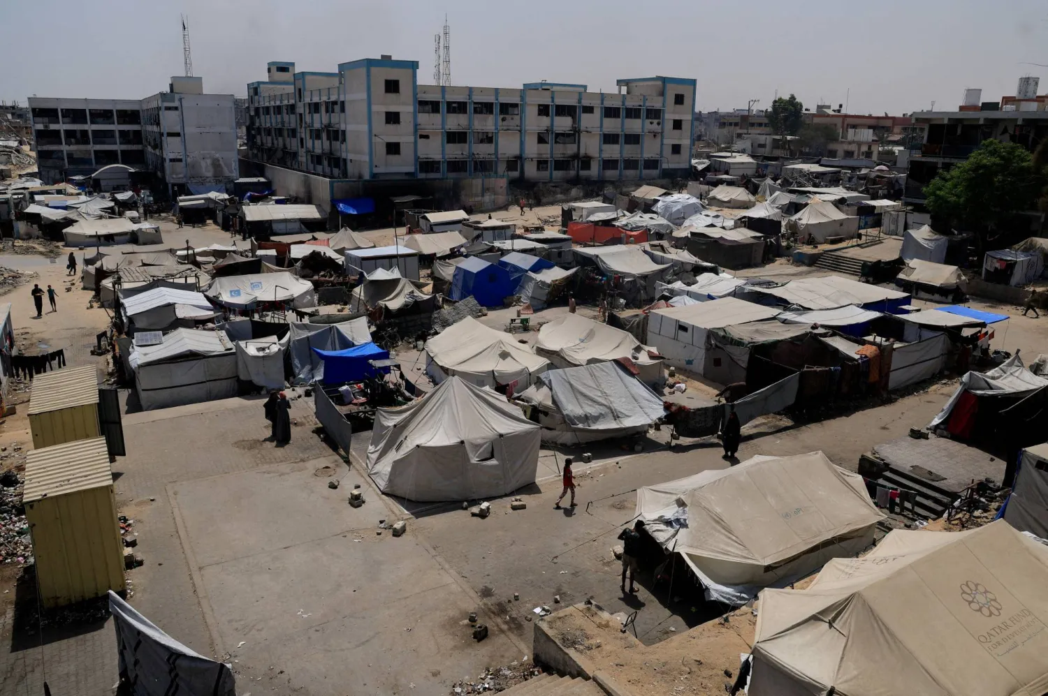 Palestinians displaced by the Israeli military offensive shelter in an UNRWA school, in Khan Younis, in the southern Gaza Strip, August 19, 2025. (Reuters)
