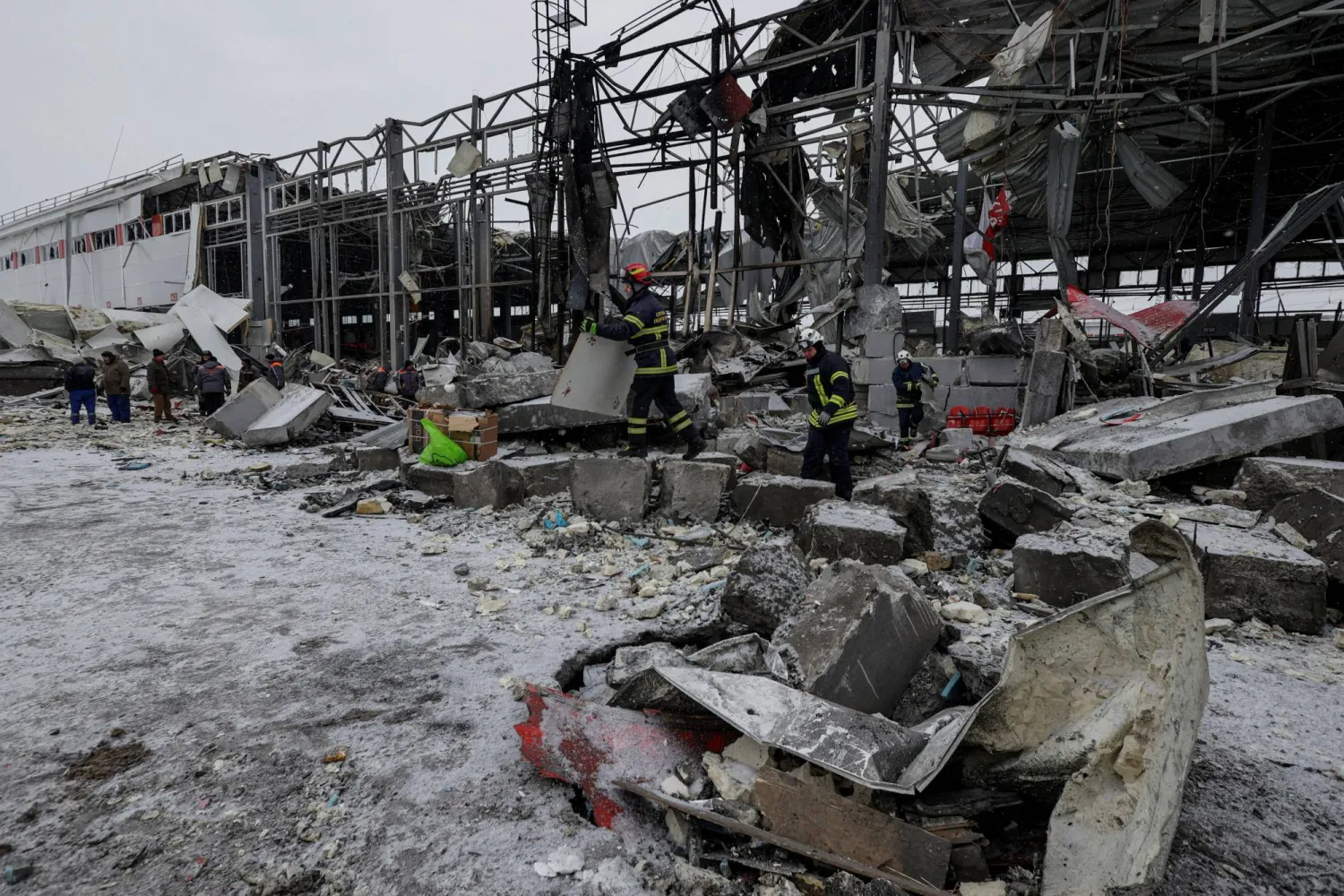 Rescuers work at the site of a logistics hub of a private delivery company hit by Russian missile strikes, amid Russia's attack on Ukraine, in Kharkiv, Ukraine January 13, 2026. (Reuters)