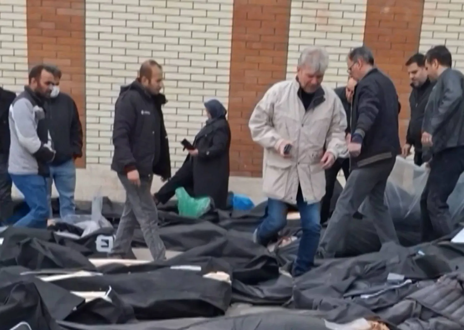 This video grab taken on January 14, 2026 from UGC images posted on social media on January 13, 2026, shows dozens of bodies lying on the ground at the Tehran Province Forensic Diagnostic and Laboratory Centre in Kahrizak, as grieving relatives search for their loved ones. (UGC / AFP) 