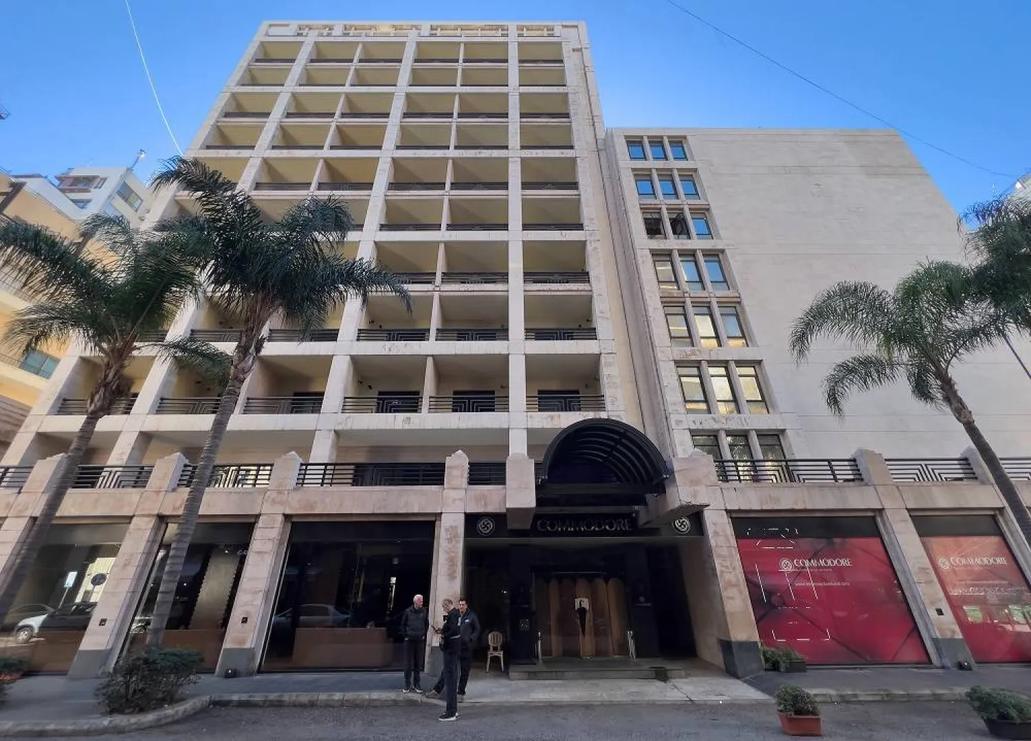 People stand outside the closed Commodore hotel, in Beirut, Lebanon, Sunday, Jan. 11, 2026. (AP)