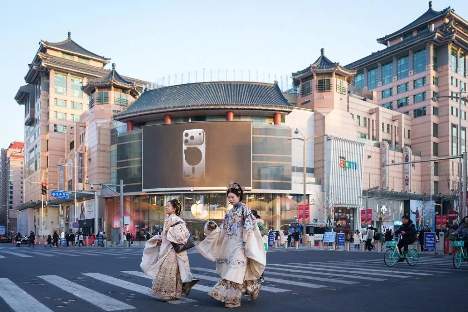 Women dressed in traditional Chinese-style attire cross a street in Beijing, China, Tuesday, Jan. 13, 2026. (AP)