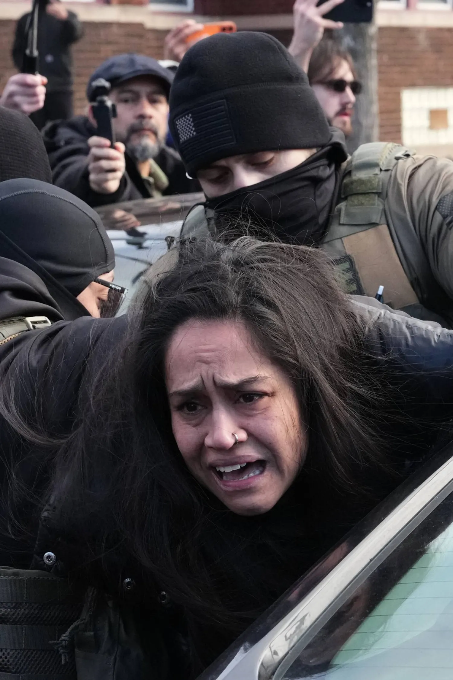 احتجاز شخص من قبل عملاء فيدراليين في مينيابوليس 13 يناير 2026 بالقرب من مكان مقتل رينيه غود برصاص ضابط من إدارة الهجرة الأسبوع الماضي (أ.ب)