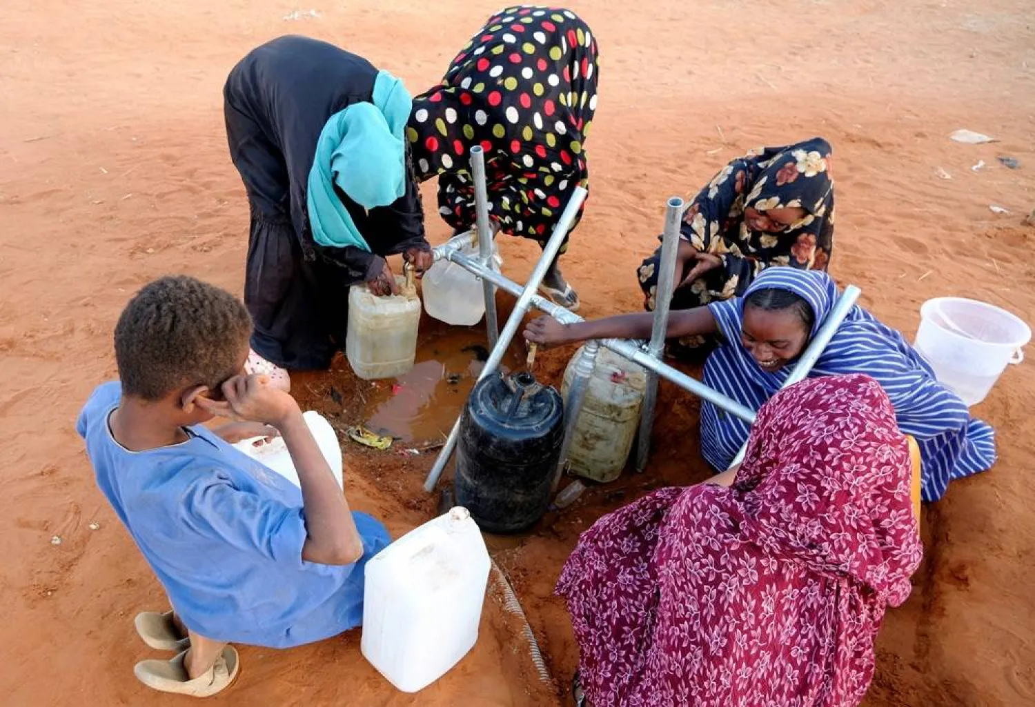 Displaced women fill water at displaced persons camp in El Obeid, North Kordofan State, Sudan, January 12, 2026. (Reuters) 