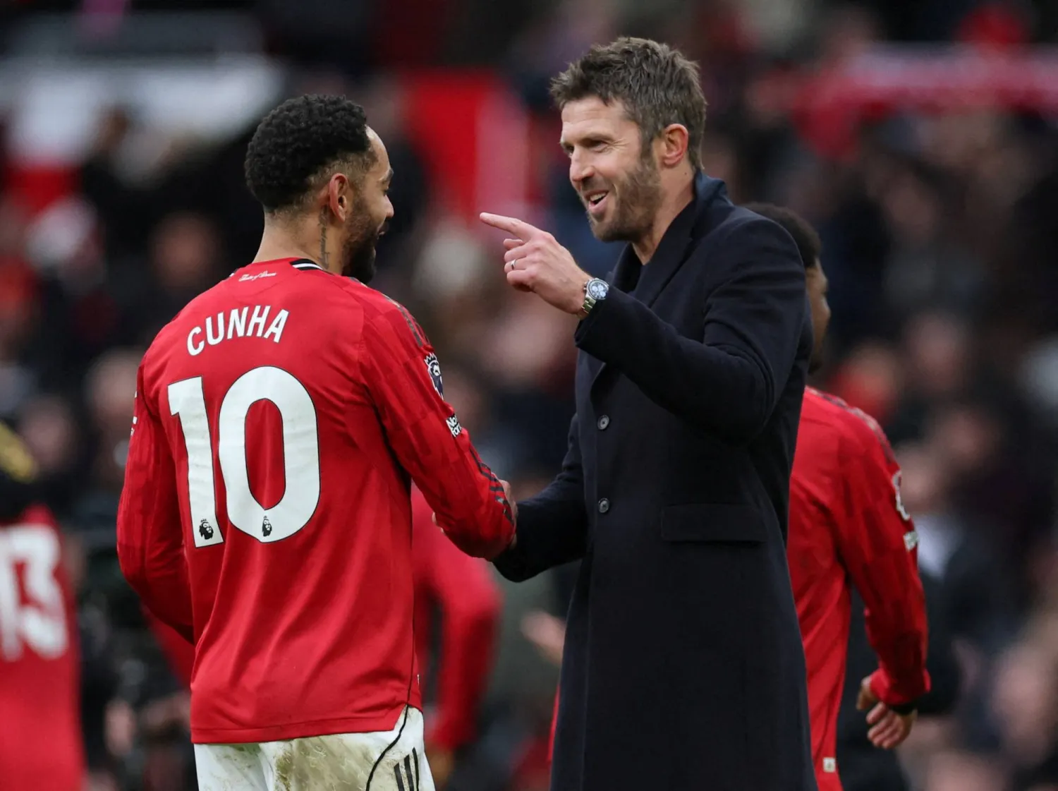 Soccer Football - Premier League - Manchester United v Manchester City - Old Trafford, Manchester, Britain - January 17, 2026 Manchester United interim manager Michael Carrick and Matheus Cunha celebrate after the match REUTERS/Phil Noble 