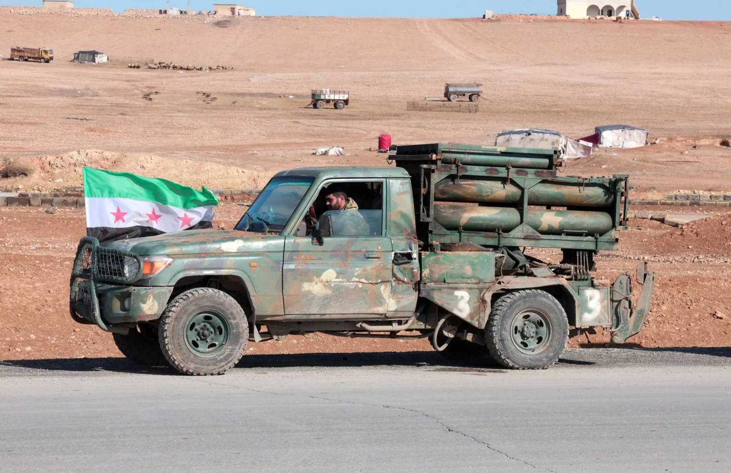 A military vehicle of the Syrian army is parked on the highway near Tabqa, after the Syrian army took control of it, Syria, January 19, 2026. (Reuters)