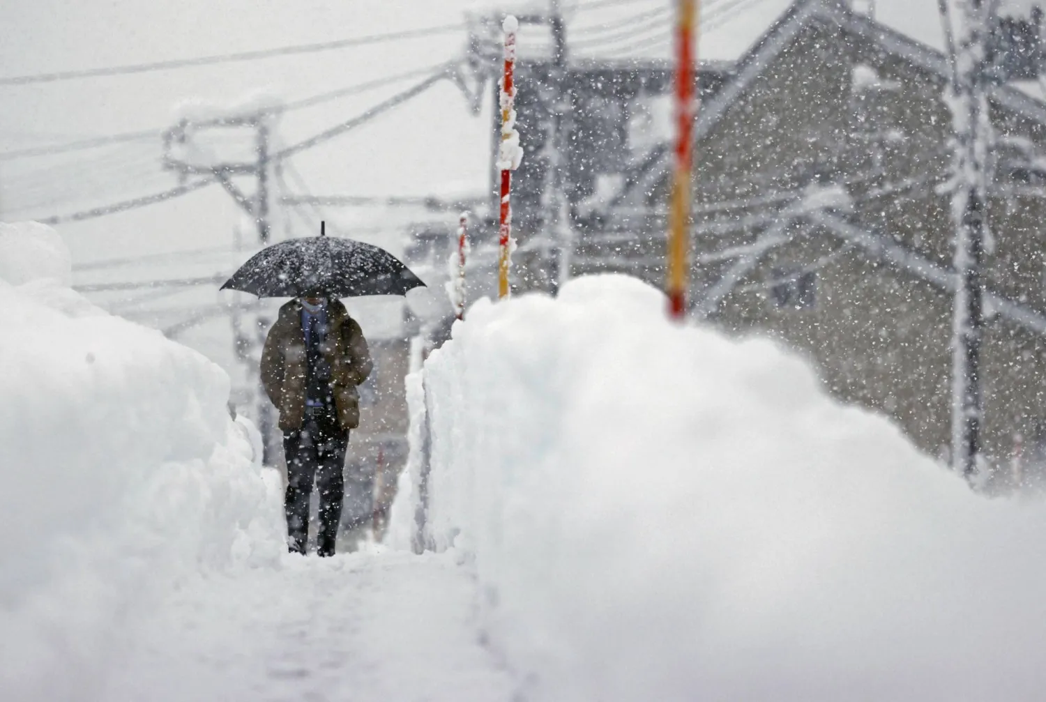 A man makes his way in the heavy snow in Uonuma, Niigata Prefecture, Japan, Dec. 20, 2022. (Reuters)