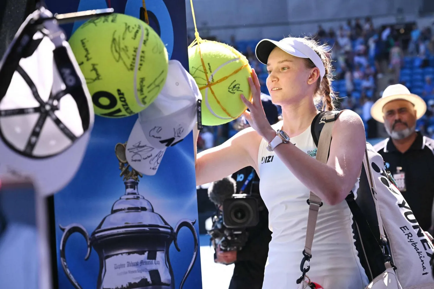 Kazakhstan's Elena Rybakina signs autographs after her victory against Slovenia's Kaja Juvan in their women's singles match on day three of the Australian Open tennis tournament in Melbourne on January 20, 2026. (AFP)