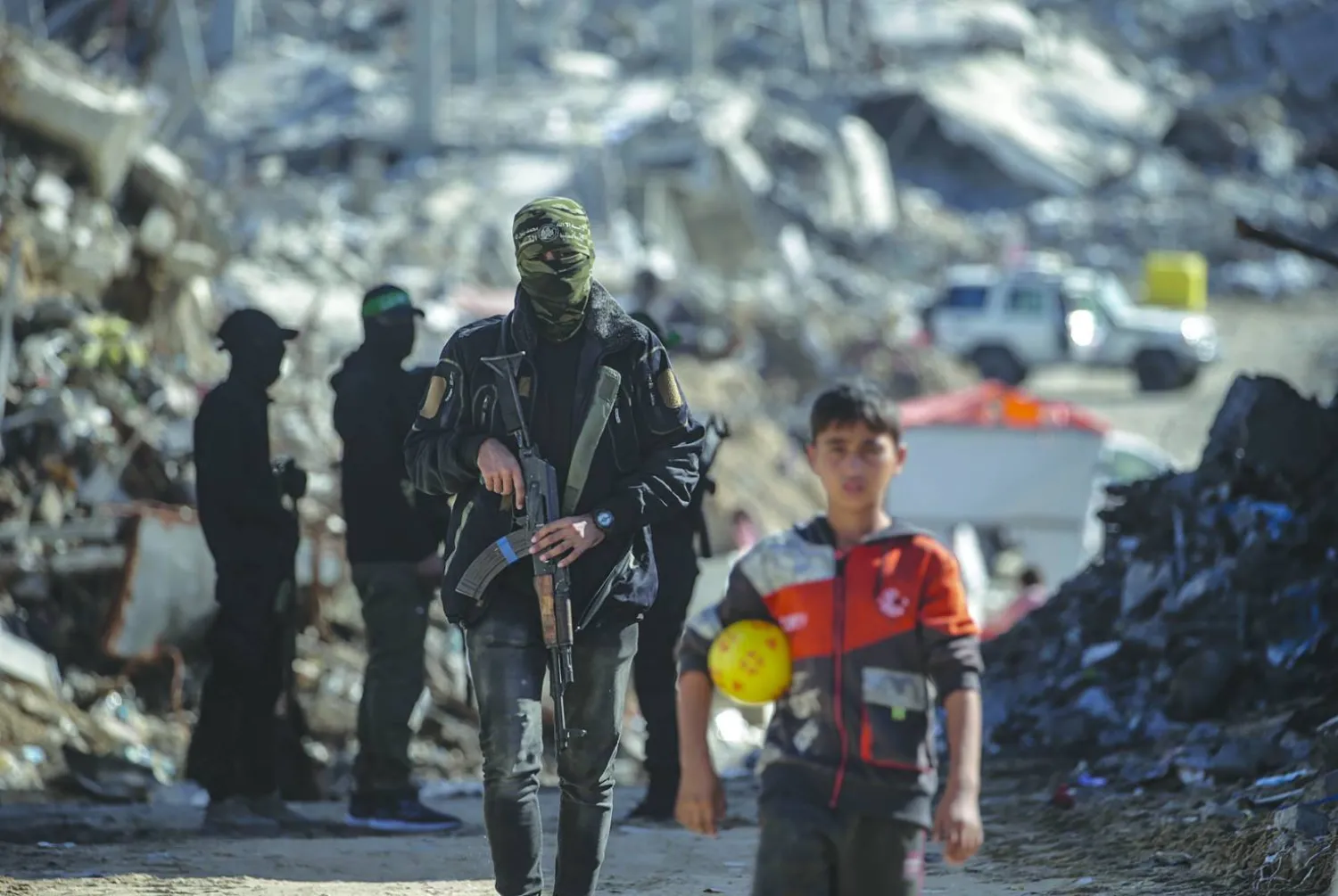 A Palestinian child is seen as fighters from Hamas’ Qassam Brigades search for the bodies of Israeli hostages in the Jabalia refugee camp in northern Gaza, last December. (EPA)