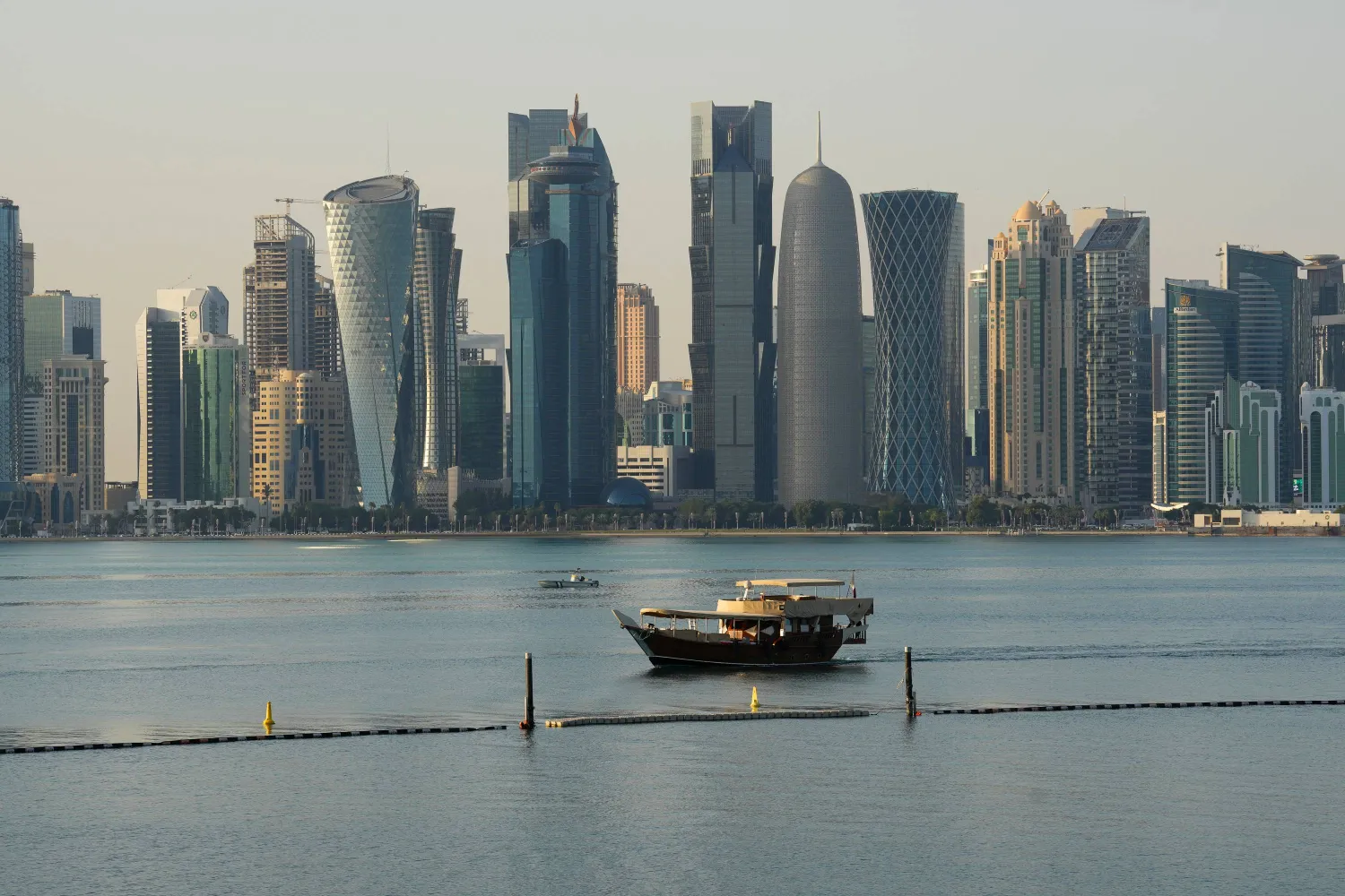A boat makes its way past the Doha skyline in Doha, Qatar on Sunday, Jan. 18, 2026. (Sean Kilpatrick/The Canadian Press via AP)