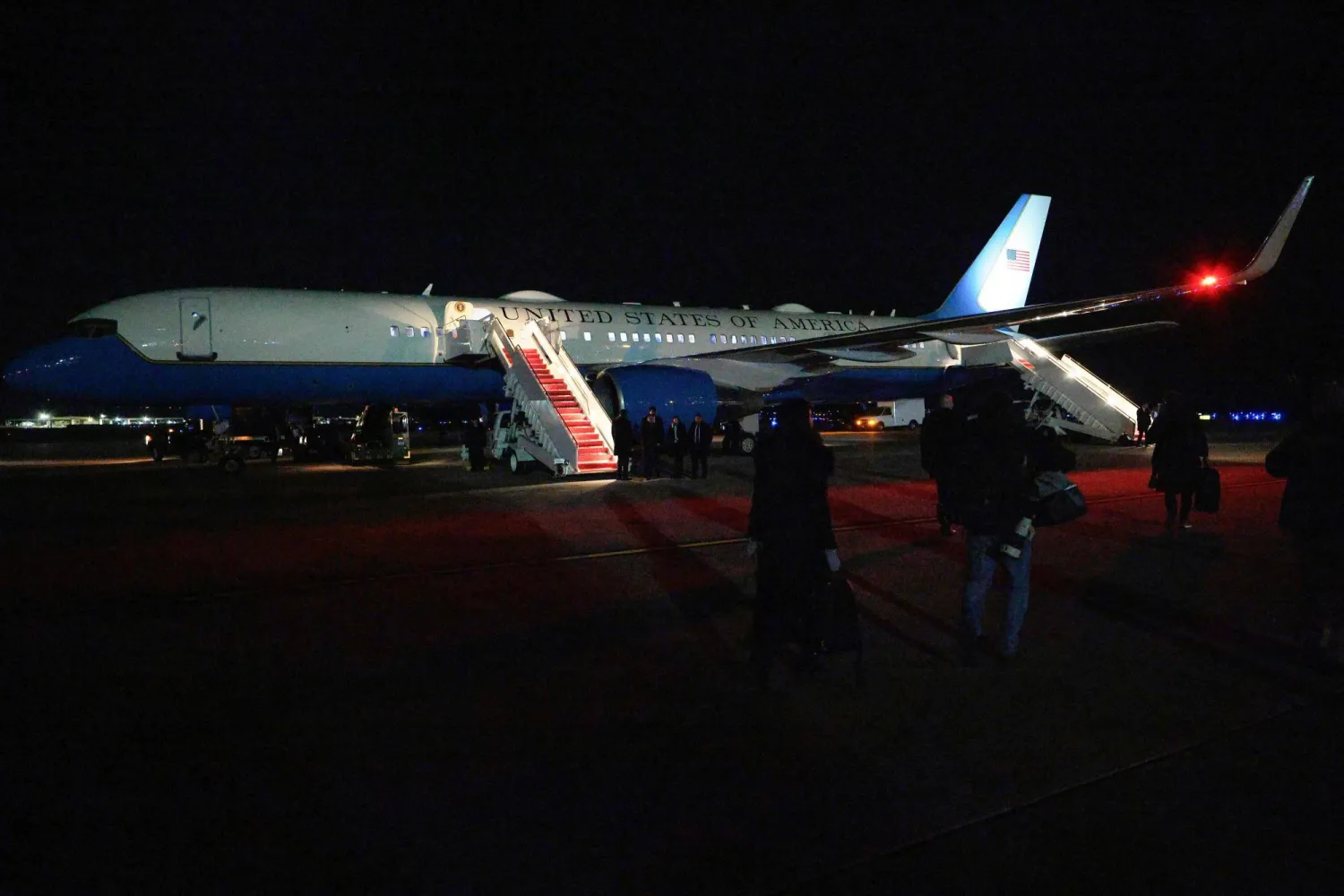 Members of the media walk toward the plane which will now carry President Trump to Switzerland after Air Force One returned to Joint Base Andrews on January 20, 2026 in Joint Base Andrews, Maryland. (Getty Images/AFP)