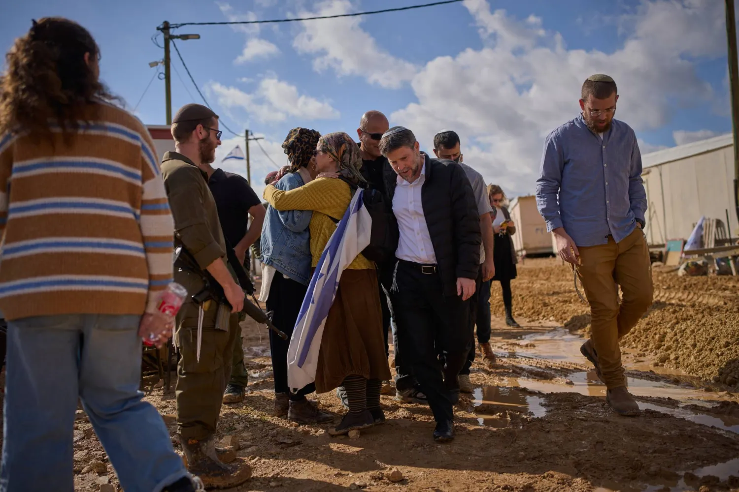 Israeli finance minister Bezalel Smotrich, center, strides through the newly-legalized Jewish settlement of Yatziv, adjacent to the Palestinian town of Beit Sahour, in the West Bank, Jan. 19, 2026. (AP)