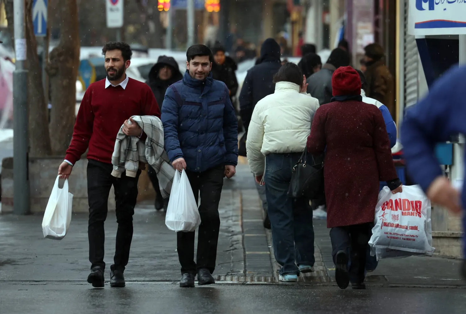 Iranians walk in street in Tehran, Iran, 20 January 2026. (EPA)