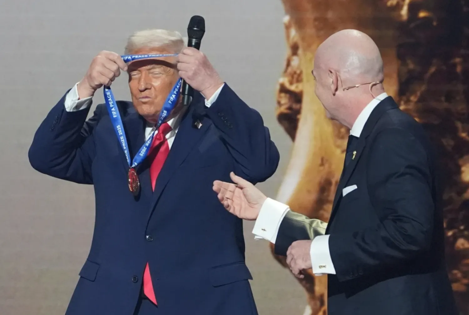 President Donald Trump is presented with the inaugural FIFA Peace Prize by FIFA President Gianni Infantino during the 2026 FIFA World Cup draw at the Kennedy Center, Dec. 5, 2025, in Washington. (AP Photo/Evan Vucci, file)