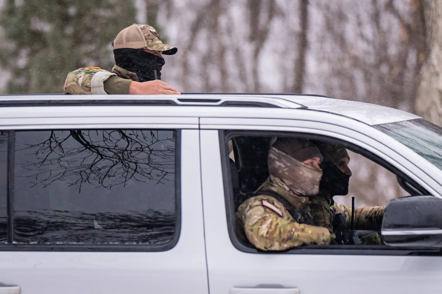 Federal agents patrol a street, Wednesday, Jan. 21, 2026, in Minneapolis. (AP Photo/Angelina Katsanis)