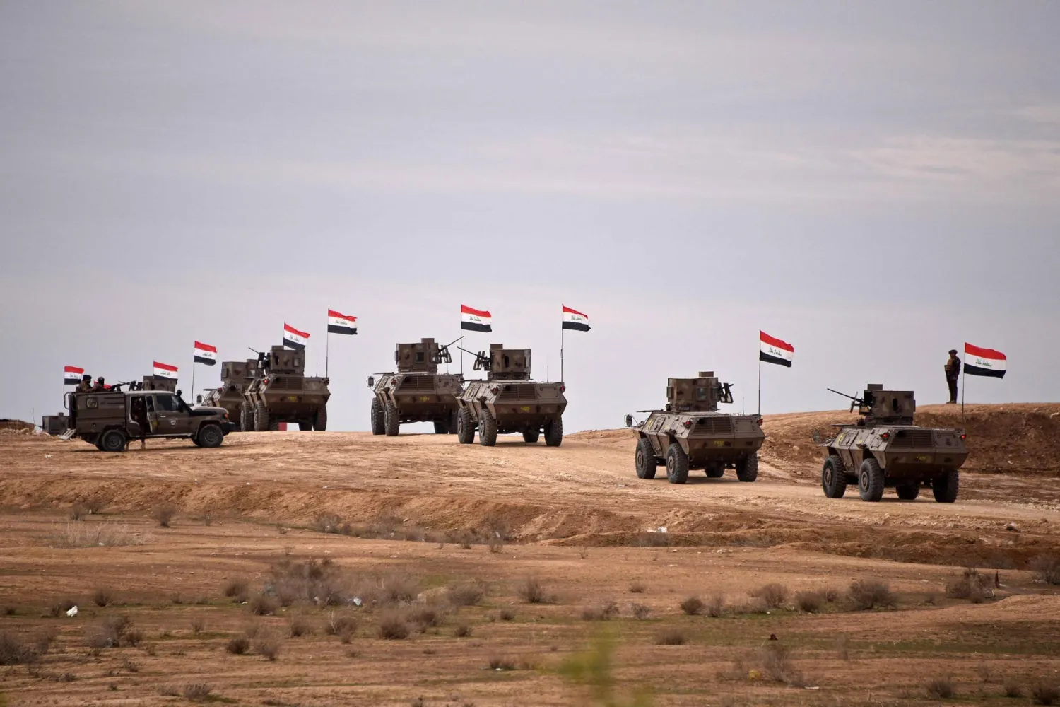 Iraqi border security force personnel patrol in their armored vehicles along the border with Syria, in Sinjar district, northern Iraq on January 22, 2026. (AFP)