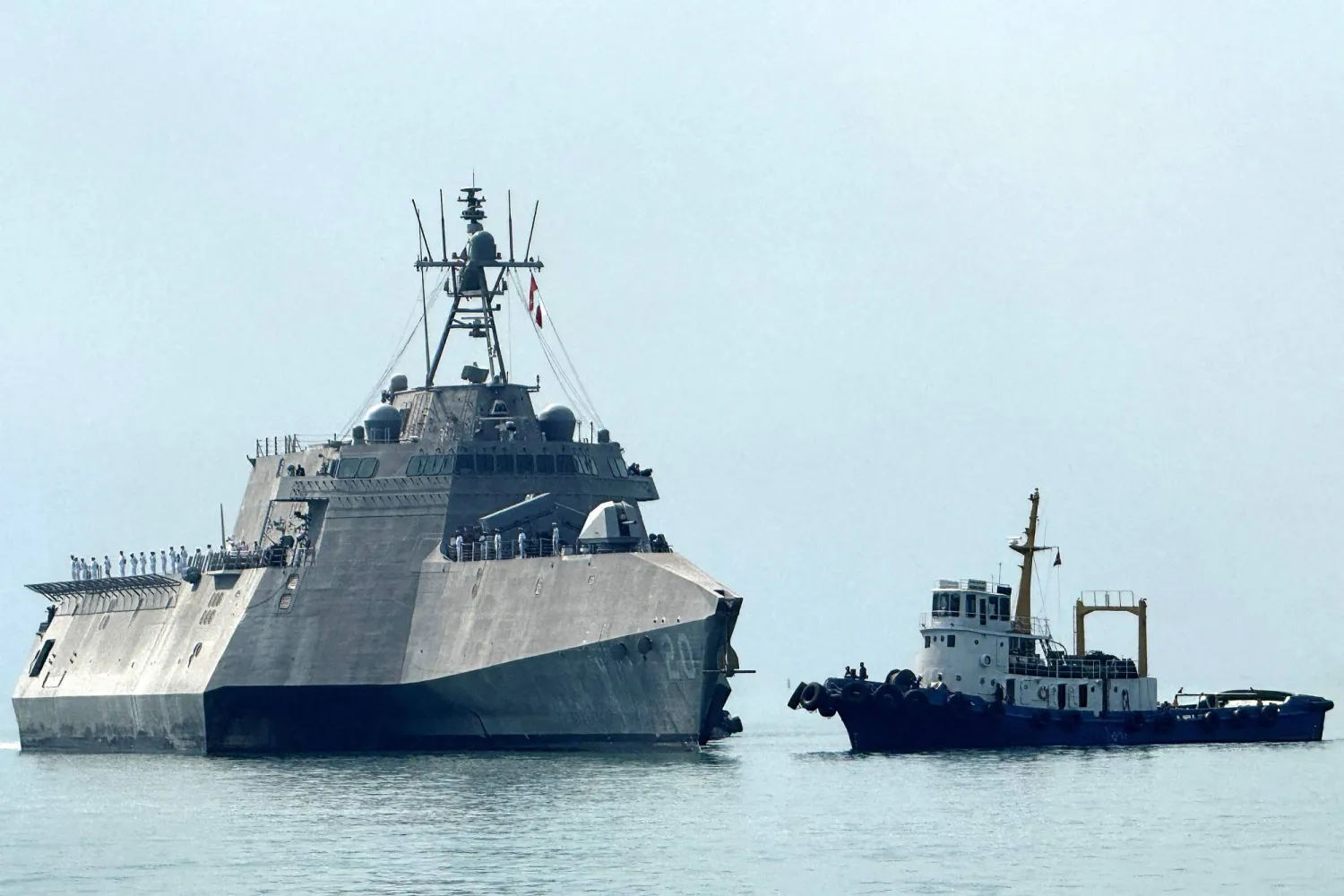 The US Navy's USS Cincinnati (LCS-20) littoral combat ship (L) arrives for a port call at the Ream Naval base, located in Cambodia's southern coast in Preah Sihanouk province, on January 24, 2026. (Photo by Suy SE / AFP)