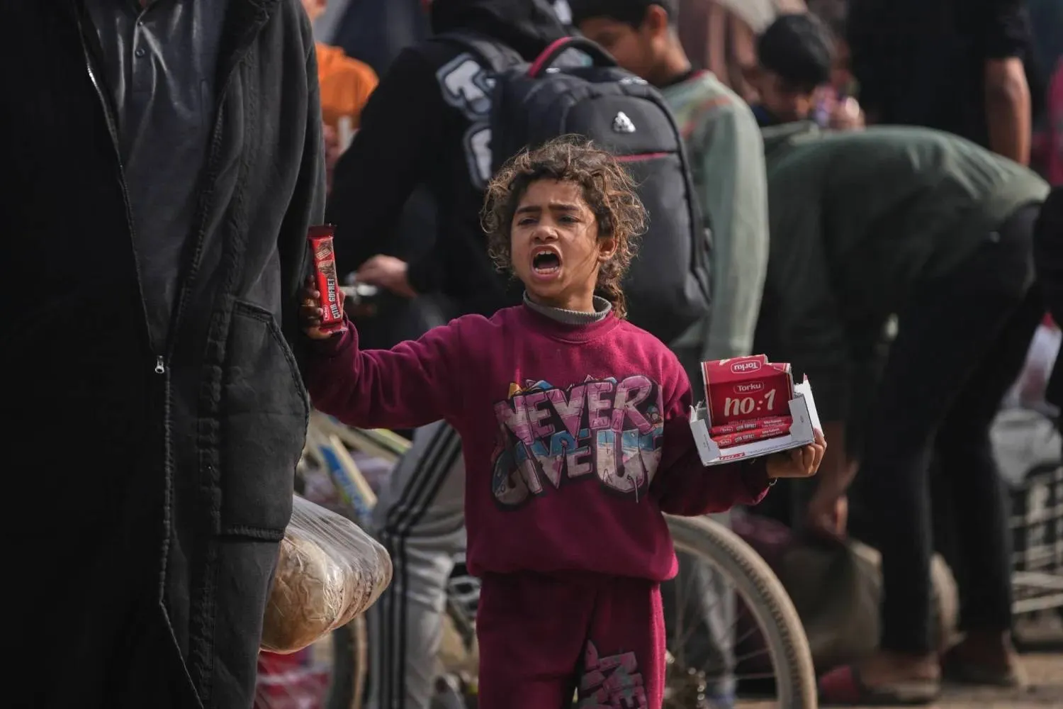 A Palestinian girl sells chocolate bars at a market in Khan Younis, southern Gaza Strip, on Friday. (AP) 