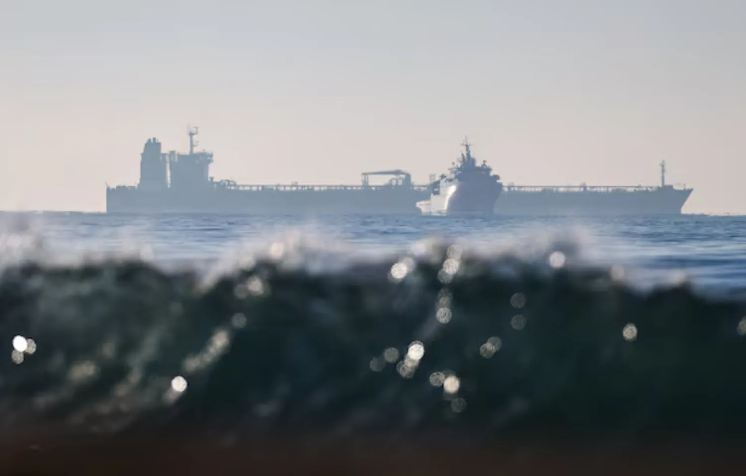 The silhouette of a French navy boat surrounding the GRINCH oil tanker, intercepted by France in the Alboran Sea on suspicion of operating under a false flag and belonging to Russia's shadow fleet that enables Russia to export oil despite sanctions, and diverted to the port of Marseille-Fos, in the Gulf of Fos-sur-Mer, - Reuters