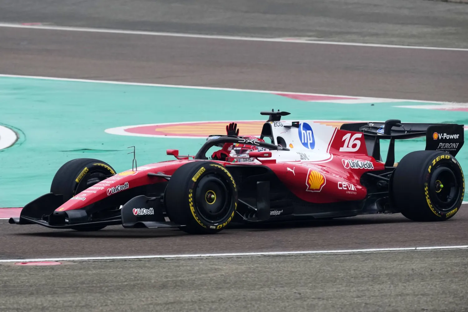 Monaco's Charles Leclerc waves to fans as he steers his Ferrari Formula One SF-26 at the Ferrari private test track, in Fiorano Modenese, Italy, Friday, Jan. 23, 2026. (AP)