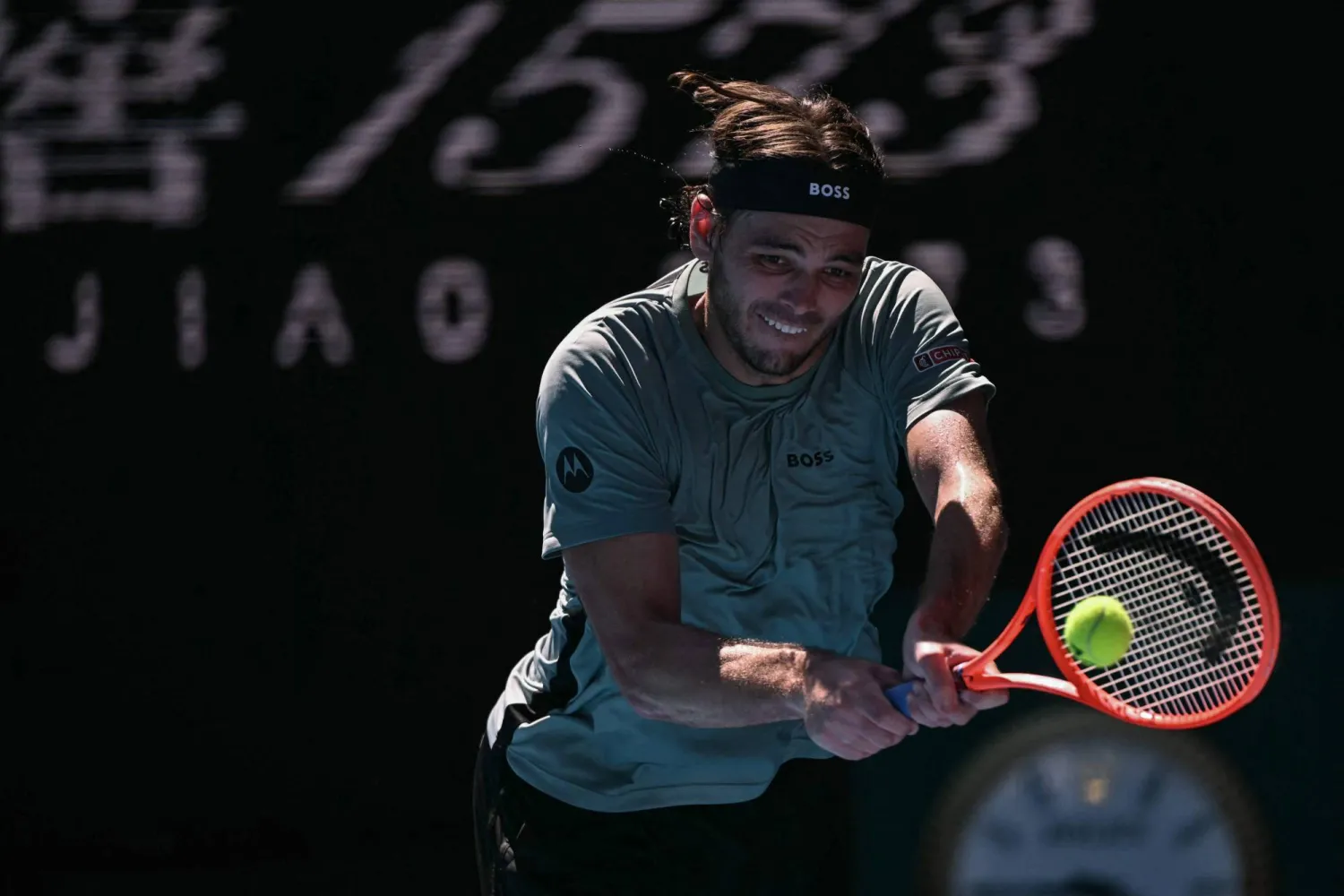 USA's Taylor Fritz hits a return to Italy's Lorenzo Musetti during their men's singles match on day nine of the Australian Open tennis tournament in Melbourne on January 26, 2026. (AFP)