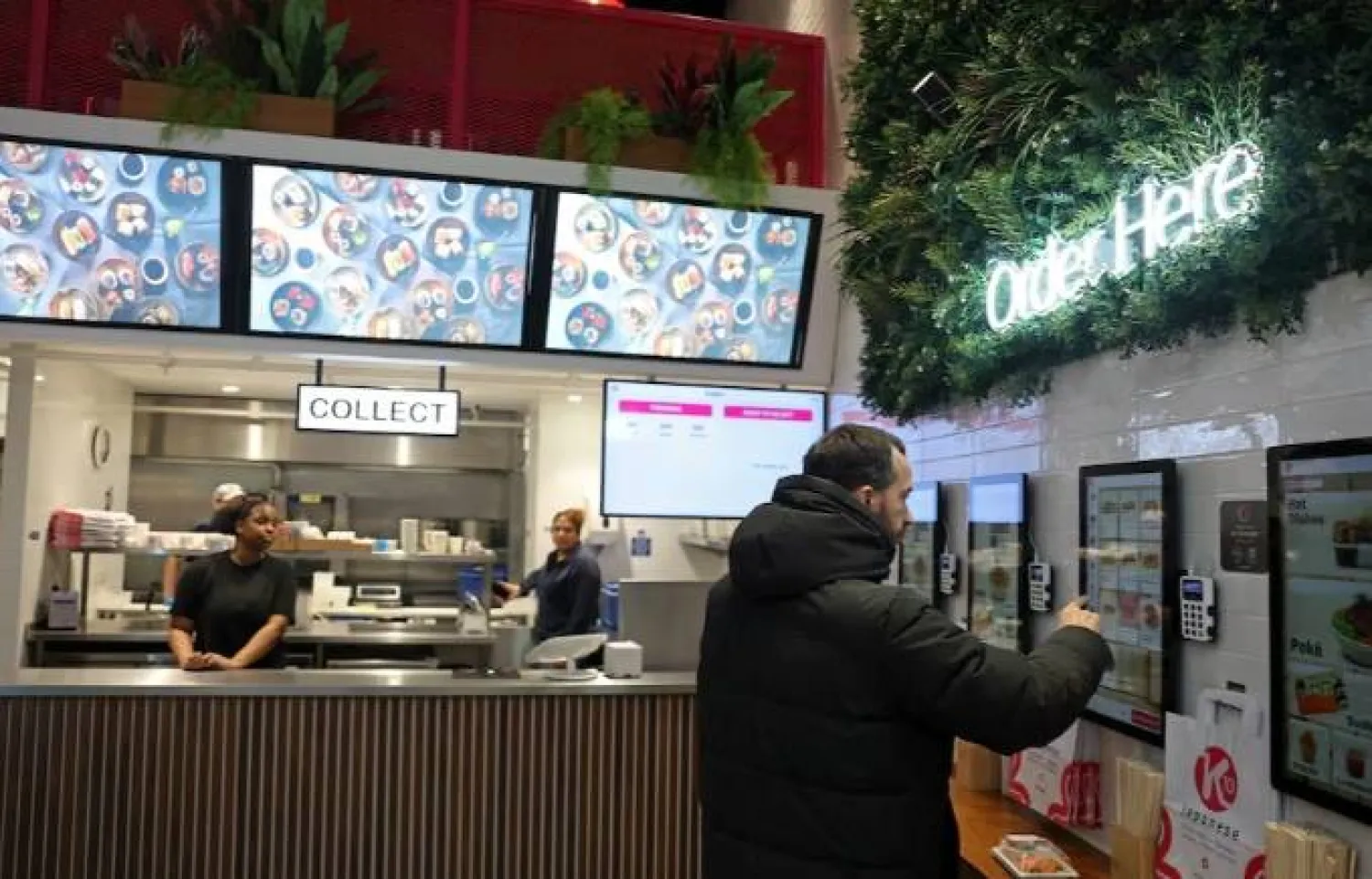 زبون يستخدم جهاز طلب إلكترونياً في مطعم ياباني بلندن (رويترز)