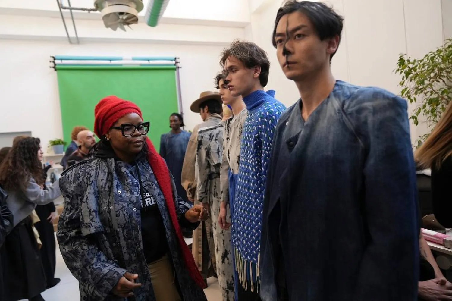 Afrofashion Association founder Michelle Ngonmo prepares models in the backstage of the Victor-Hart Fall/Winter 2026-2027 Men's fashion show presented in Milan, Italy, Jan. 18, 2026. (AP)