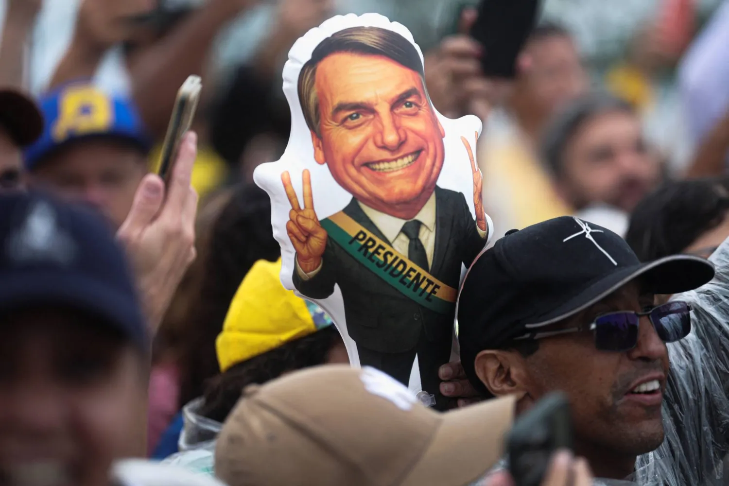 A depiction of former Brazilian President Jair Bolsonaro is held by a protester during a demonstration following a march entitled "Walk for Freedom and Justice," led by opposition congressman Nikolas Ferreira, as participants arrive in Brasilia after a 240‑km walk from Paracatu to protest in support of Bolsonaro, who is serving a 27‑year sentence for plotting a coup, in Brasilia, Brazil, January 25, 2026. (Reuters)