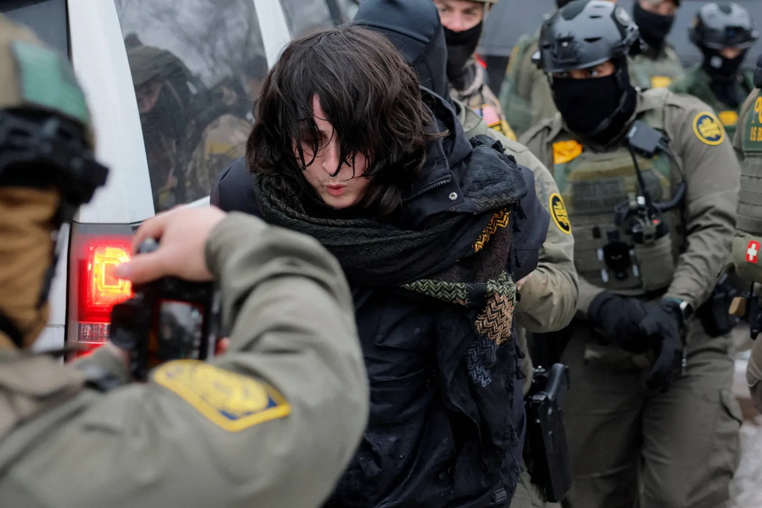 US Border Patrol Agents, including one carrying a camera and working with Border Patrol commander Greg Bovino, detain a protester a day after the fatal shooting of Renee Nicole Good by a US Immigration and Customs Enforcement (ICE) agent, in Minneapolis, Minnesota, US, January 8, 2026. REUTERS/Brian Snyder     