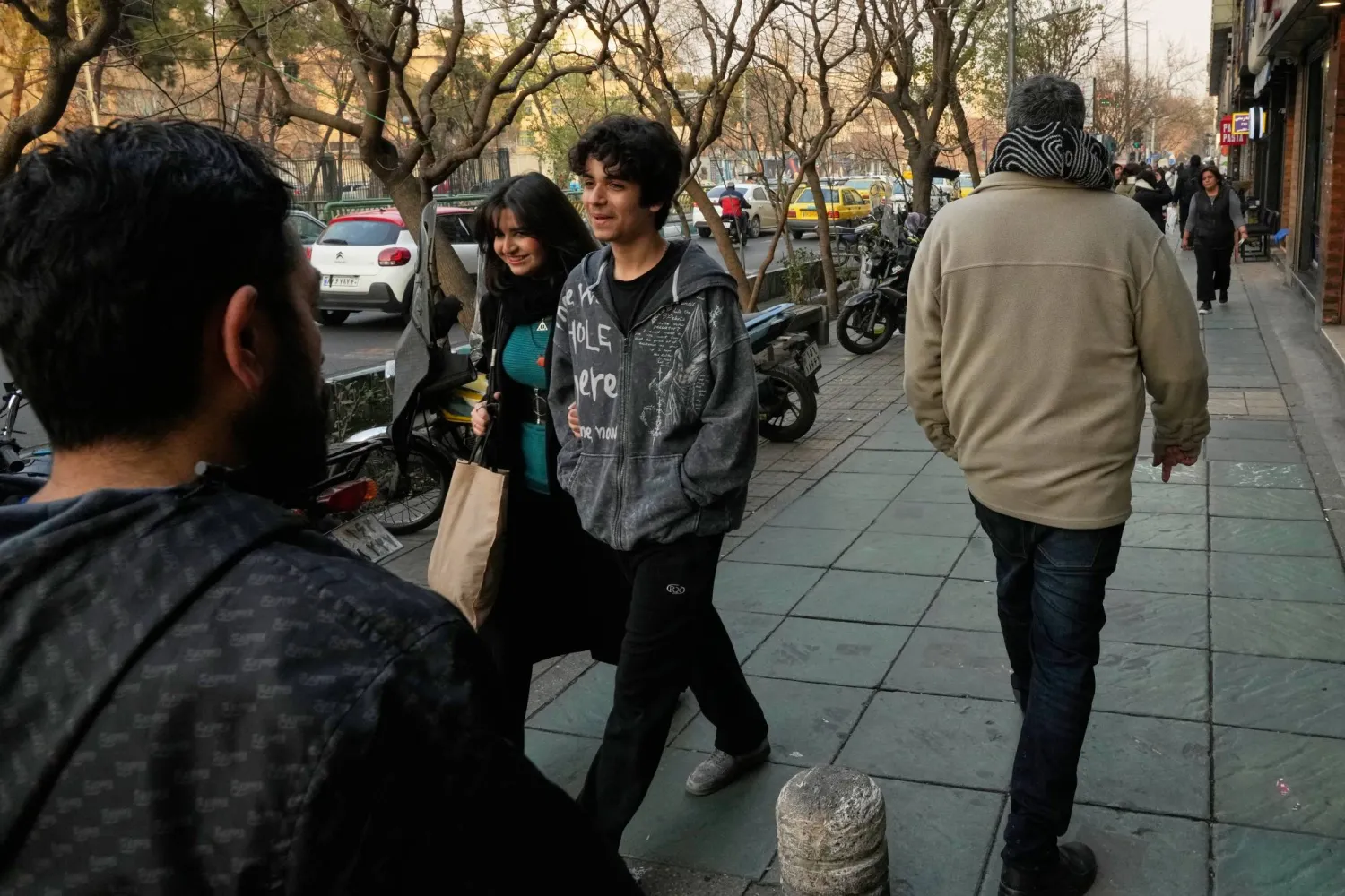  People walk on a sidewalk at the Enqelab-e-Eslami street in downtown Tehran, Iran, Sunday, Jan. 25, 2026. (AP) 