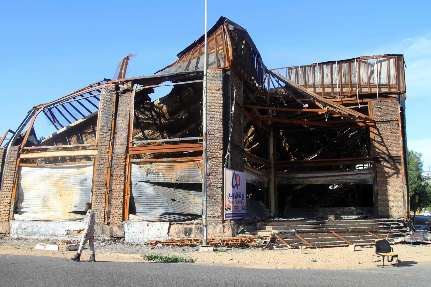 A member of security walks in front of a destroyed building as efforts to restore the city's infrastructure resumes after nearly three years of devastation caused by war, in the Sudanese capital Khartoum on January 17, 2025. (AFP)