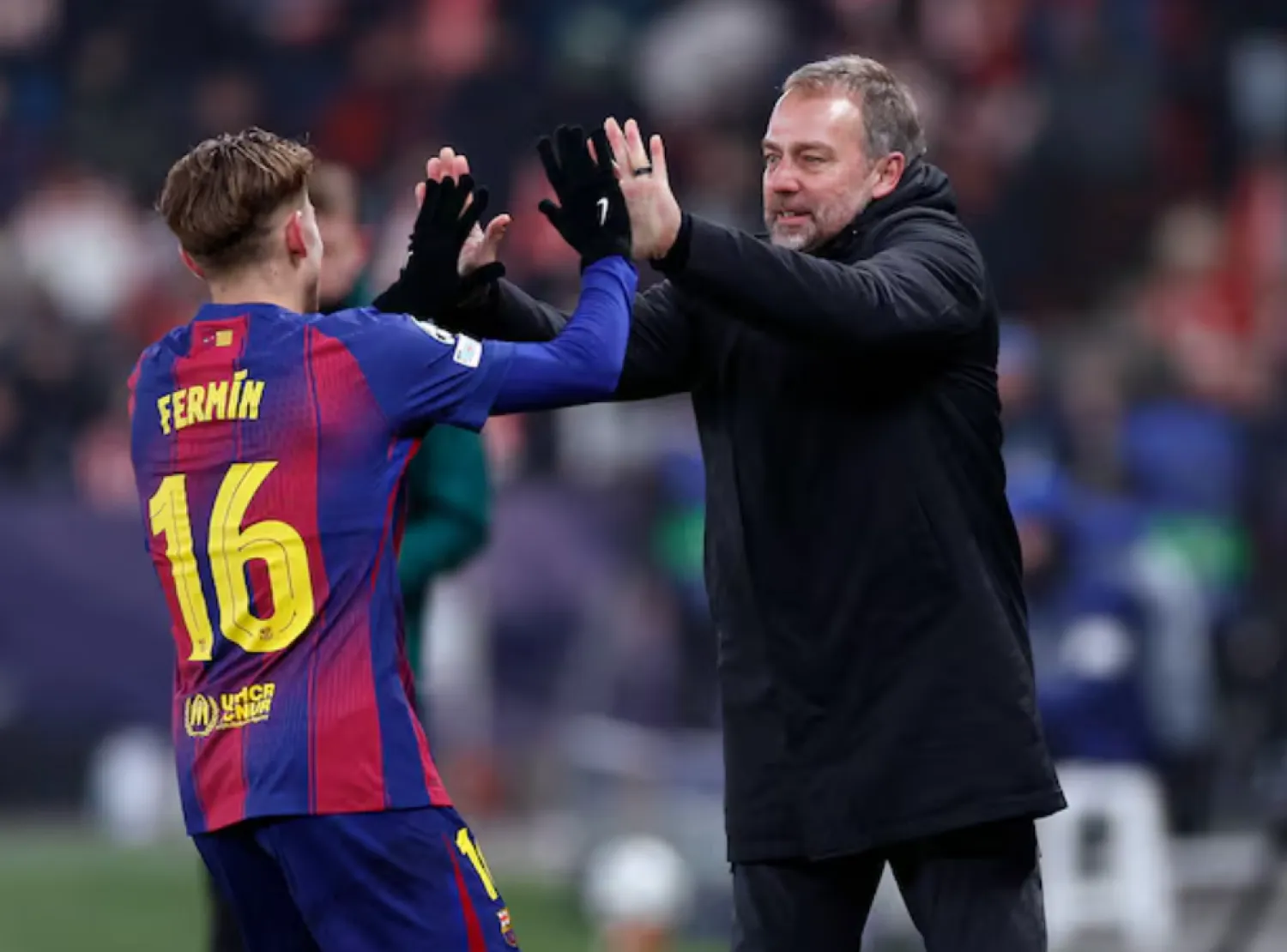 Soccer Football - UEFA Champions League - Slavia Prague v FC Barcelona - Fortuna Arena, Prague, Czech Republic - January 21, 2026 FC Barcelona's Fermin Lopez celebrates scoring their second goal with FC Barcelona coach Hansi Flick REUTERS/David W Cerny