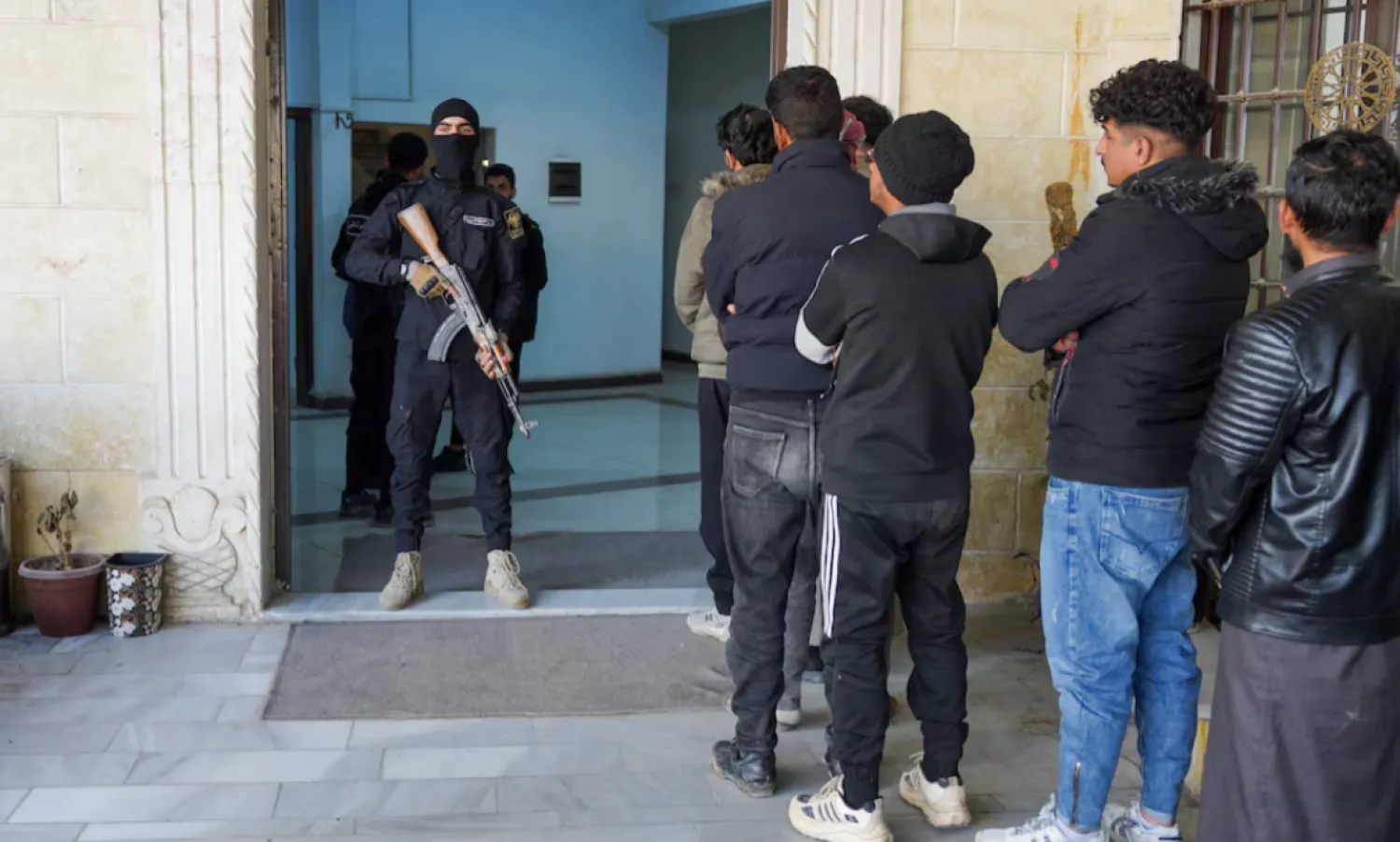 Members of the Kurdish-led Syrian Democratic Forces (SDF) queue to settle their status with Syrian government in Raqqa, Syria January 27, 2026. REUTERS/Karam al-Masri 