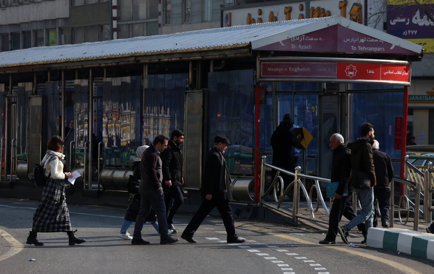 Iranians walk along a street in Tehran, Iran, 27 January 2026. (EPA)