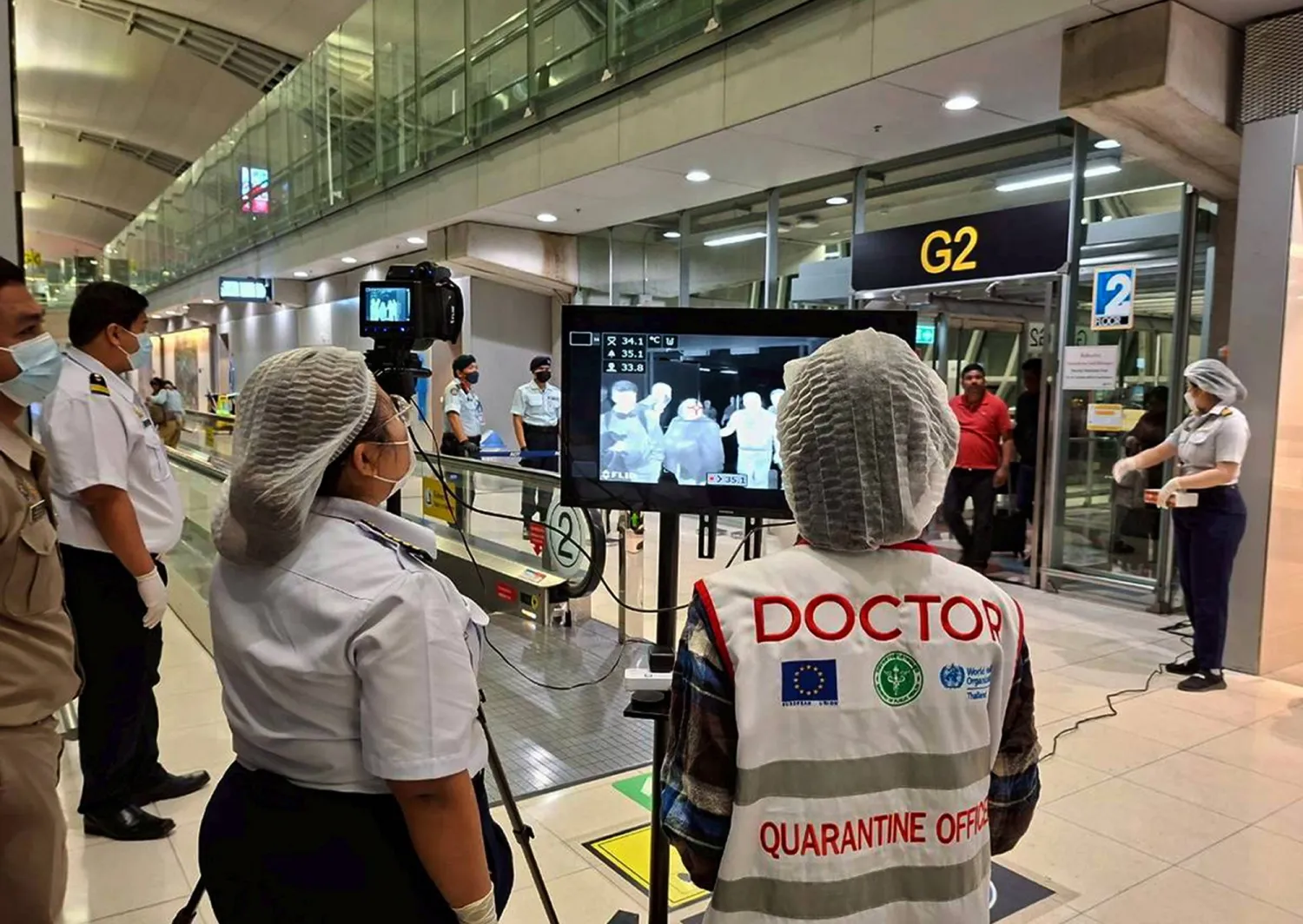 A handout photo released by Suvarnabhumi Airport shows Thai health officials wearing protective masks monitoring passengers from international flights arriving at Suvarnabhumi Airport, Samut Prakan province, Thailand, 25 January 2026. (EPA/The Suvarnabhumi Airport Office Handout)