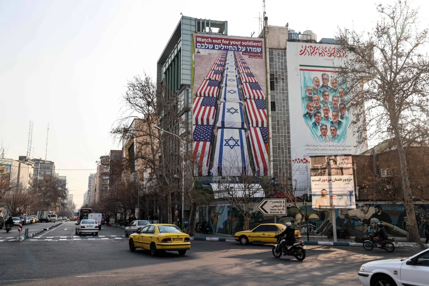 A photograph shows an anti-US and anti-Israel banner hanging on a building in Palestine Square in Tehran on January 27, 2026. (AFP)
