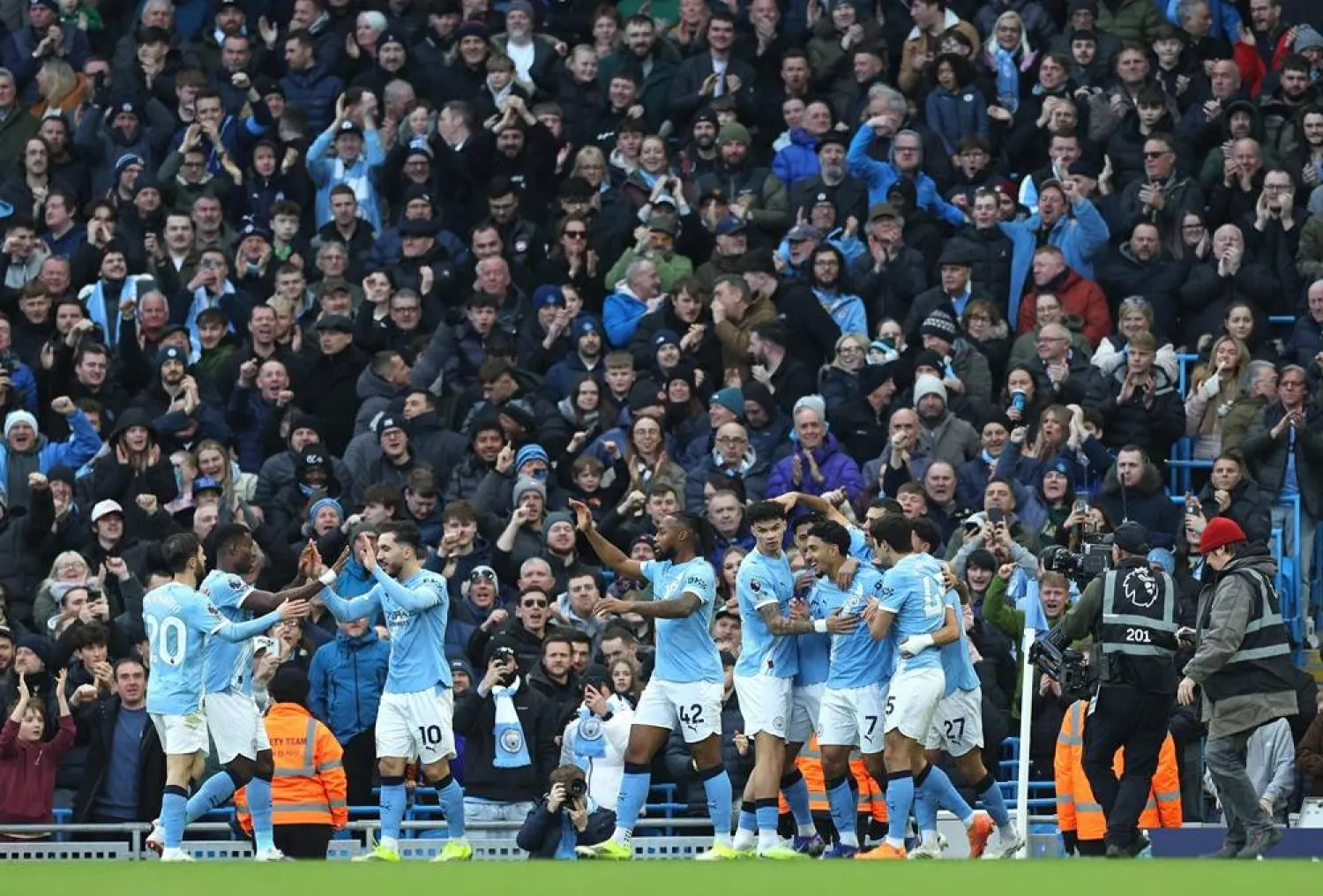 Manchester City's Egyptian striker #07 Omar Marmoush (3R) is mobbed by teammates after scoring the opening goal during the English Premier League football match between Manchester City and Wolverhampton Wanderers at the Etihad Stadium in Manchester, north west England, on January 24, 2026. (AFP)