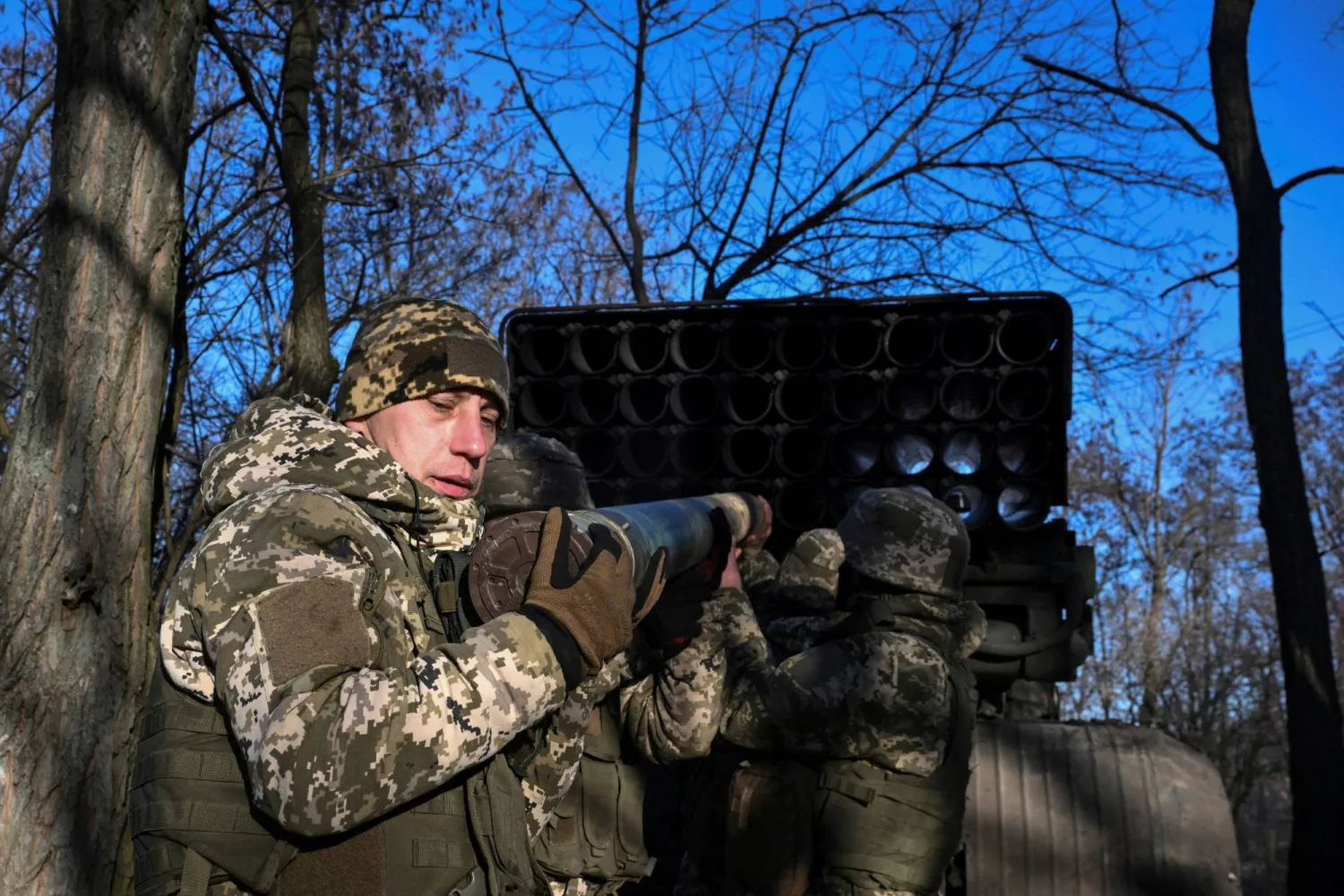 FILE PHOTO: Service members of the 152nd Jaeger Brigade of the Ukrainian Armed Forces load a shell into a BM-21 Grad multiple rocket launch system at their position in a front line, amid Russia's attack on Ukraine, in Donetsk region, Ukraine December 25, 2025. REUTERS/Stringer/File Photo
