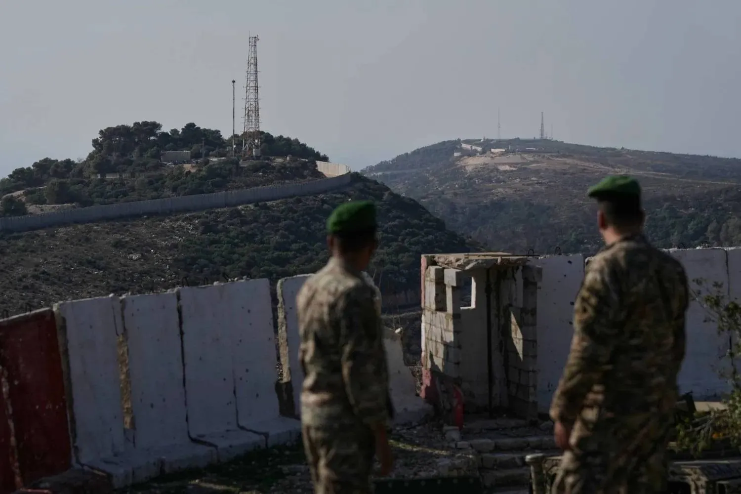 Lebanese army soldiers look toward the Israeli military position of Hanita (left) and the Labbouneh position, part of the five hills occupied by Israeli forces since last year (right), from a Lebanese military post in the village of Alma al-Shaab in southern Lebanon, Nov. 28, 2025. (AP) 