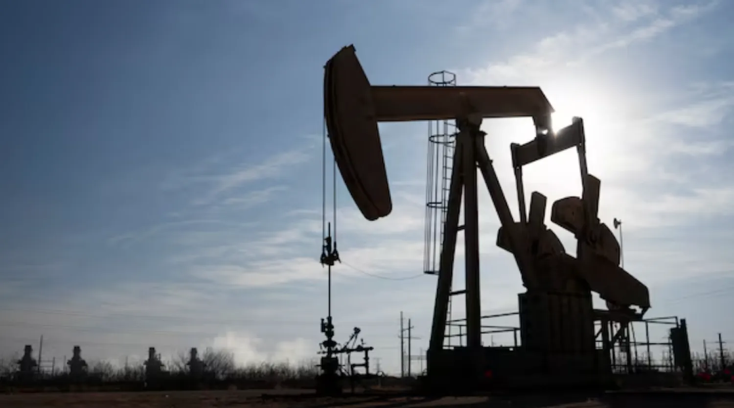 A pump jack operates near a gas turbine power plant in the Permian Basin oil field outside of Odessa, Texas, US February 18, 2025. REUTERS/Eli Hartman 