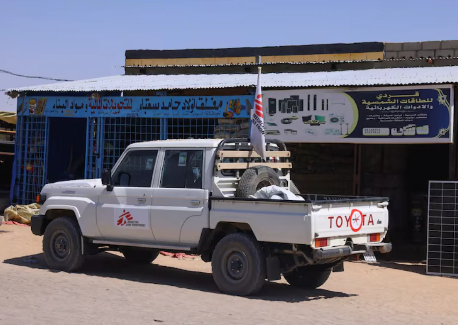 A pickup truck of the Medecins Sans Frontieres (MSF), stands in front of a market stall for solar energy equipment, in the city of Tine, eastern Chad, November 25, 2025. REUTERS/Amr Abdallah Dalsh