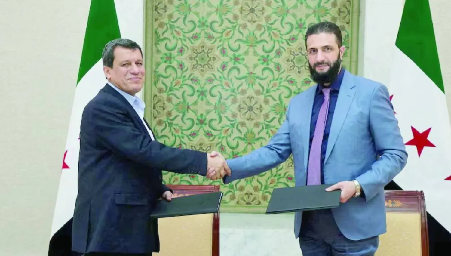Syrian President Ahmed al-Sharaa shakes hands with Mazloum Abdi, commander of the "Syrian Democratic Forces" in Damascus, March 10, 2025 (SANA)