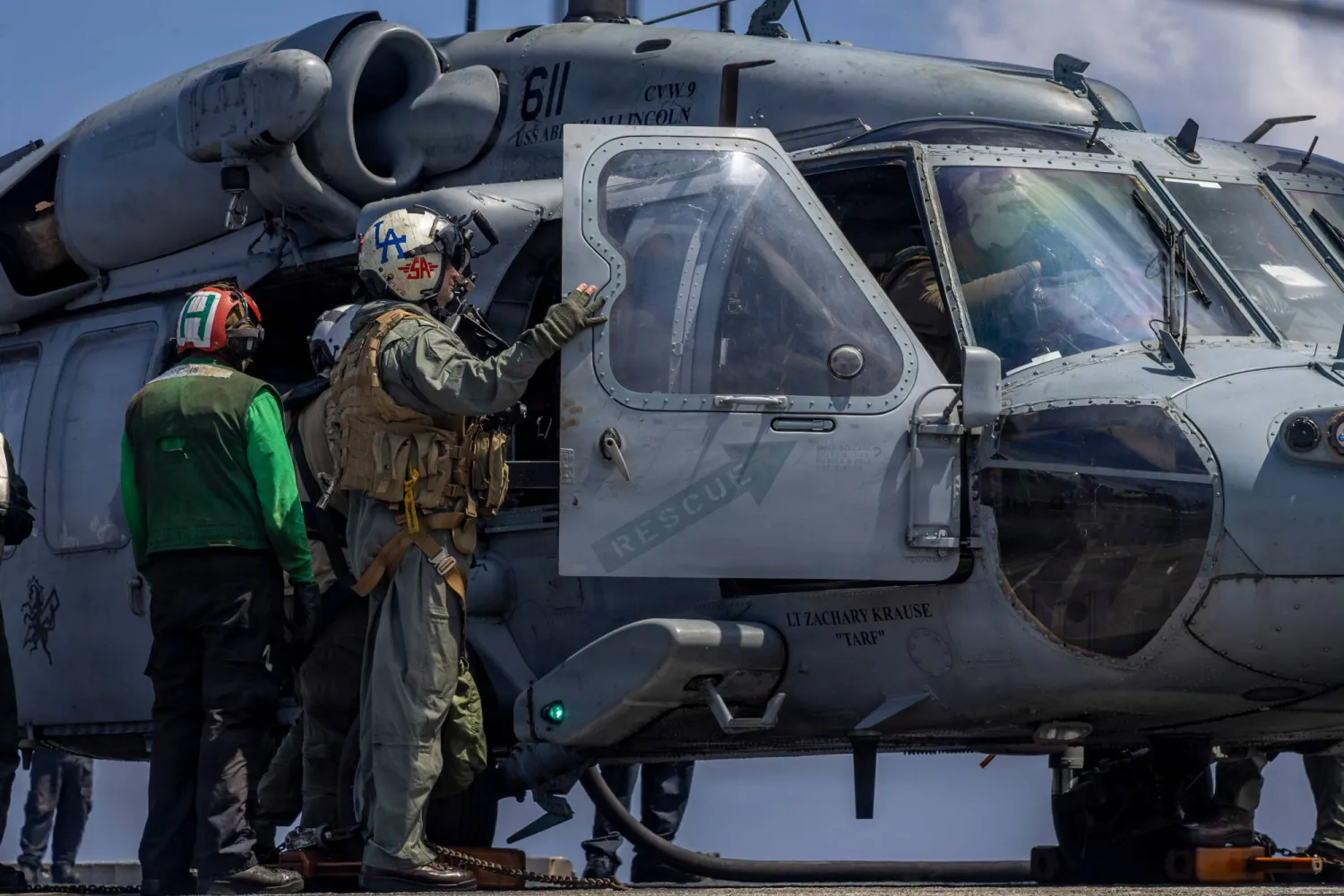 This handout image from the US Navy shows Capt. Daniel Keeler, the commanding officer of the Nimitz-class aircraft carrier USS Abraham Lincoln, as he prepares to fly an MH-60R Sea Hawk helicopter in the Indian Ocean on Jan. 23, 2026. (Mass Communication Specialist Seaman Daniel Kimmelman/US Navy via AP)