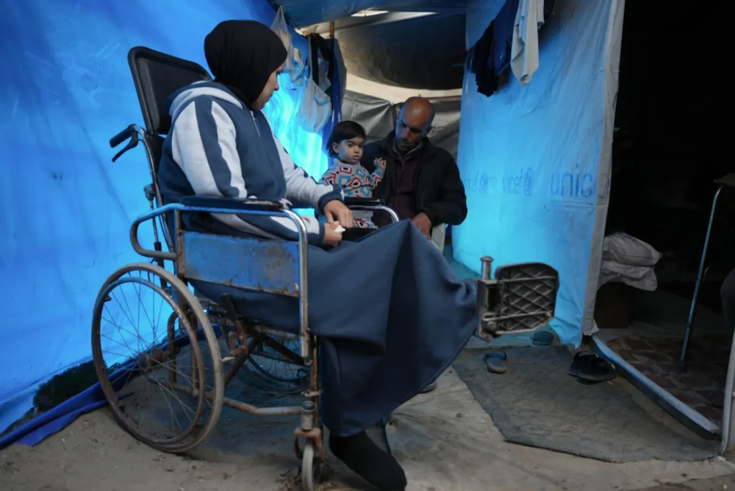 Islam Saleh, who was injured in her left leg in an Israeli strike on a school shelter in Jabalia in 2024, sits in a wheelchair inside her family’s tent in Zawaida, Gaza Strip, Tuesday, Jan. 27, 2026, as she awaits permission to travel outside Gaza for treatment. (AP Photo/Abdel Kareem Hana)
