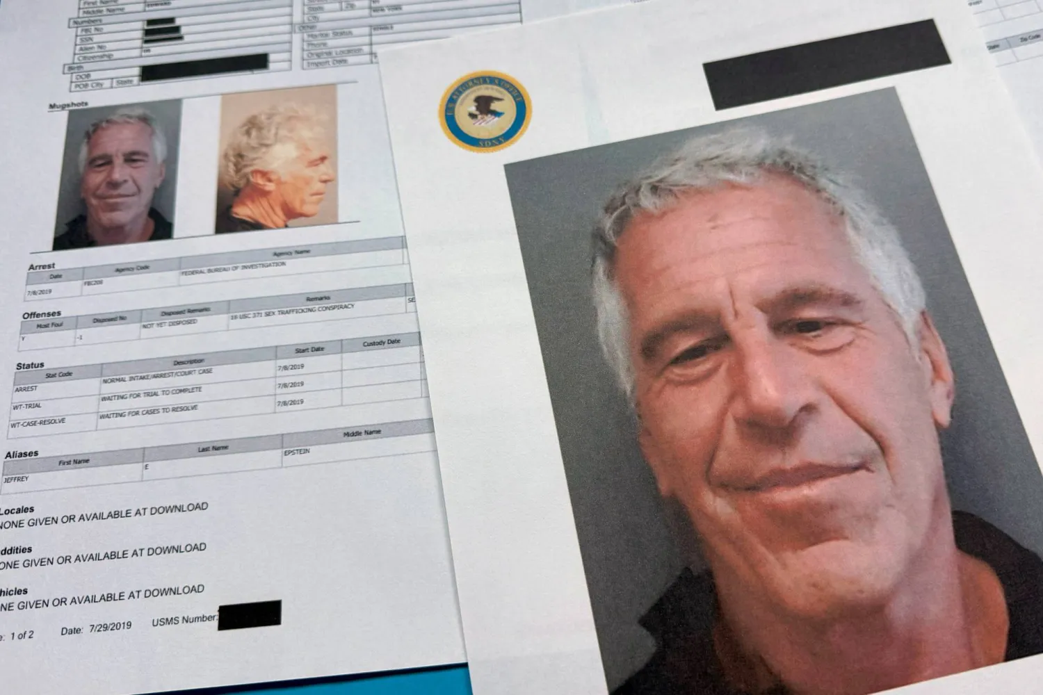 FILE - Documents that were included in the US Department of Justice release of the Jeffrey Epstein files are photographed Friday, Jan. 2, 2026. (AP Photo/Jon Elswick, File)