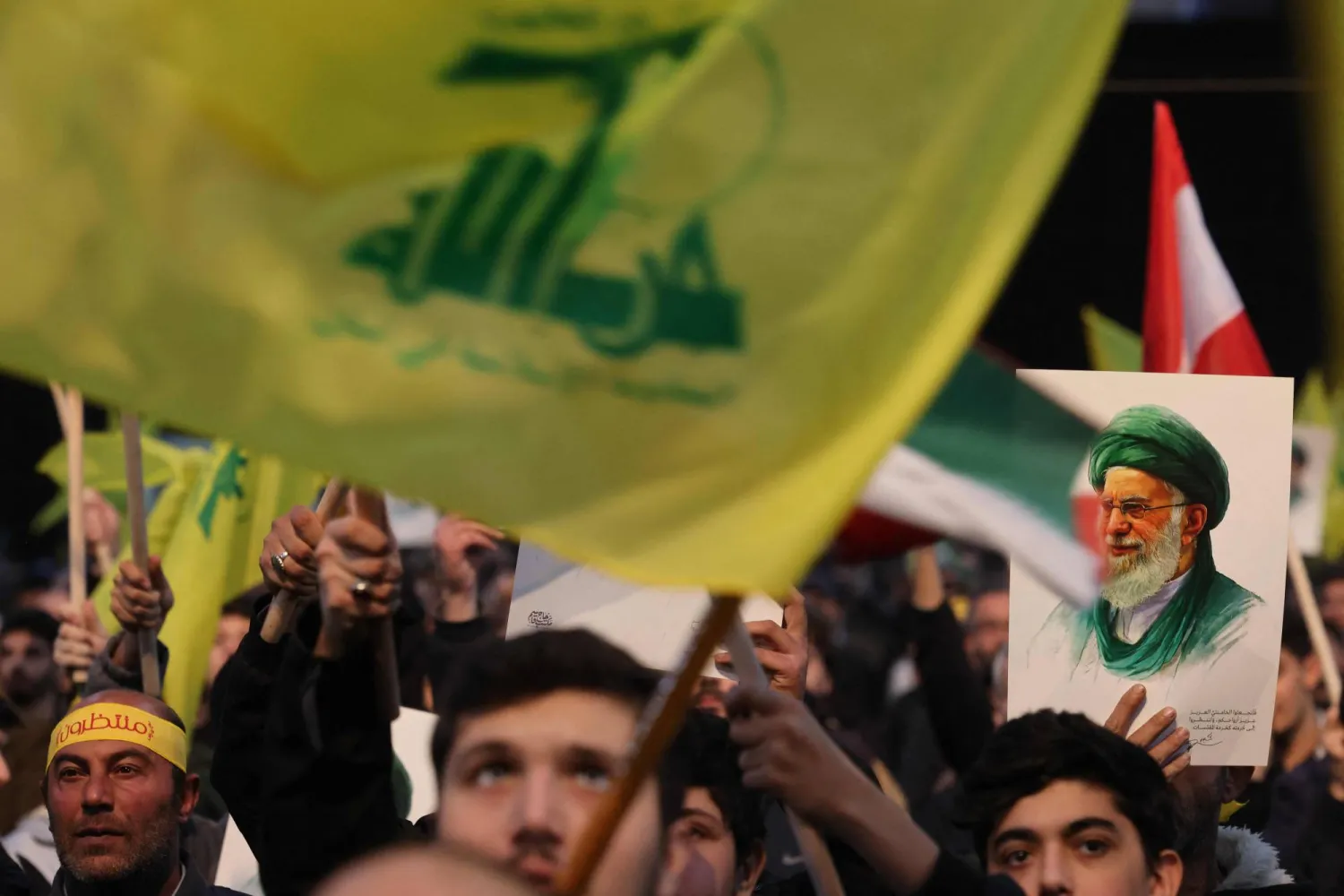 A supporter of Hezbollah holds a portrait of Iran's Supreme Leader Ali Khamenei during a rally to show their solidarity with Iran, in the southern suburb of Beirut on January 26, 2026. (AFP)