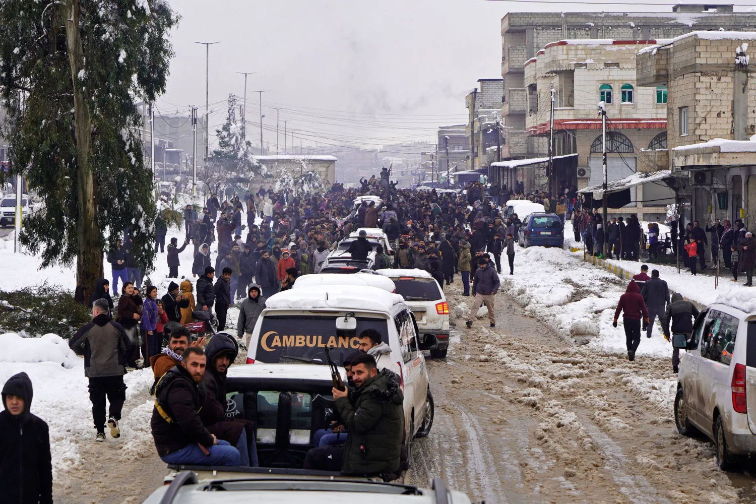 TOPSHOT - Members of Kurdish-led Syrian Democratic Forces (SDF) arrive at the Kurdish-held city of Ain al-Arab, also known as Kobane on January 23, 2026, after they withdrew from the Al-Aqtan prison in the Raqa province of Syria. (Photo by AFP)