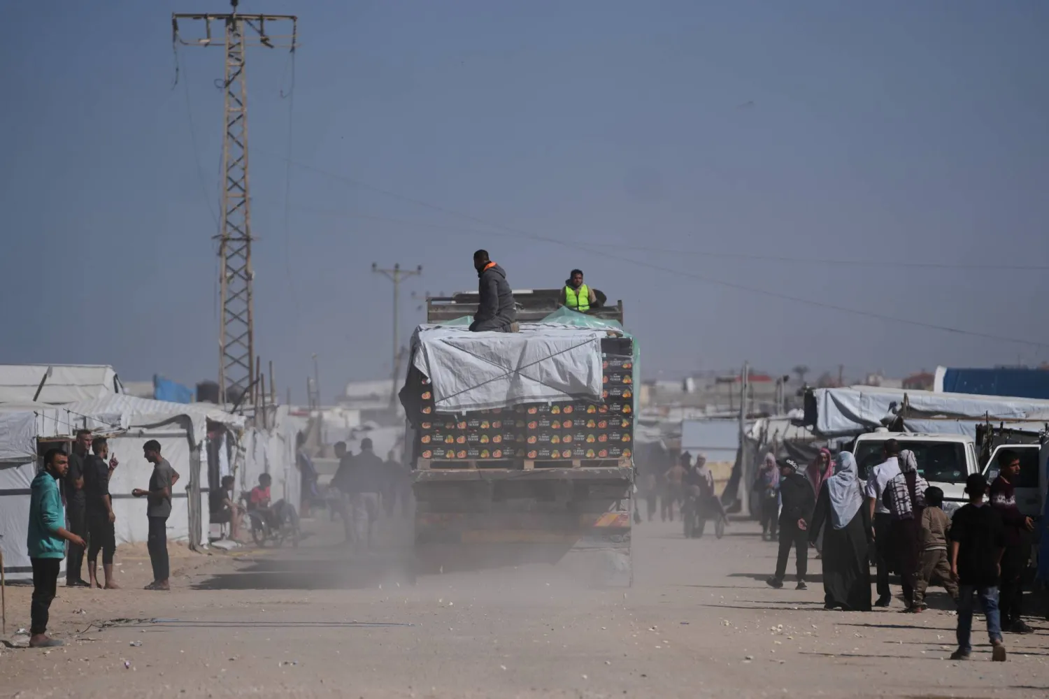 Trucks carrying food, after entering the Gaza Strip through the Kerem Shalom crossing, drive through Khan Younis, Sunday, Feb. 1, 2026. (AP Photo/Abdel Kareem Hana)