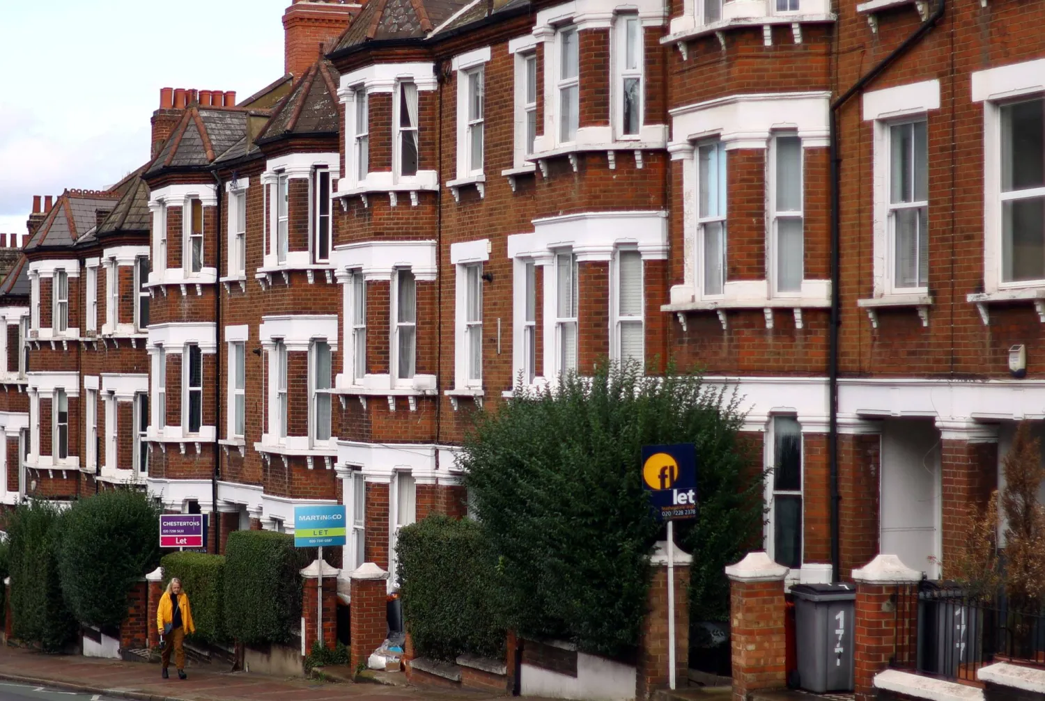 A woman walks past houses ‘To Let’ in a residential street in London, Britain, September 27, 2022. REUTERS/Hannah McKay/File Photo 