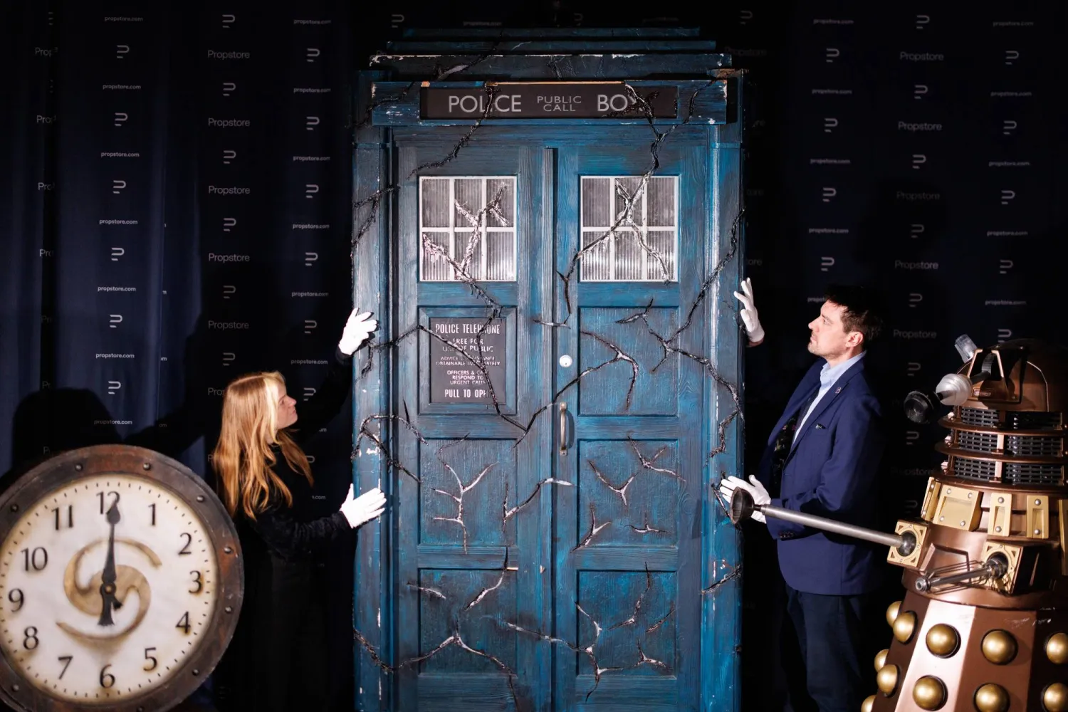 Propstore employees pose with a screen-matched TARDIS (C), a Bronze Asylum Dalek (R) and a Sardickton Clock (L), which were used in the filming of the "Doctor Who" TV series, during a photocall for the upcoming "Doctor Who" auction by Propstore auction house in Rickmansworth, Hertfordshire, Britain, 30 January 2026. (EPA)