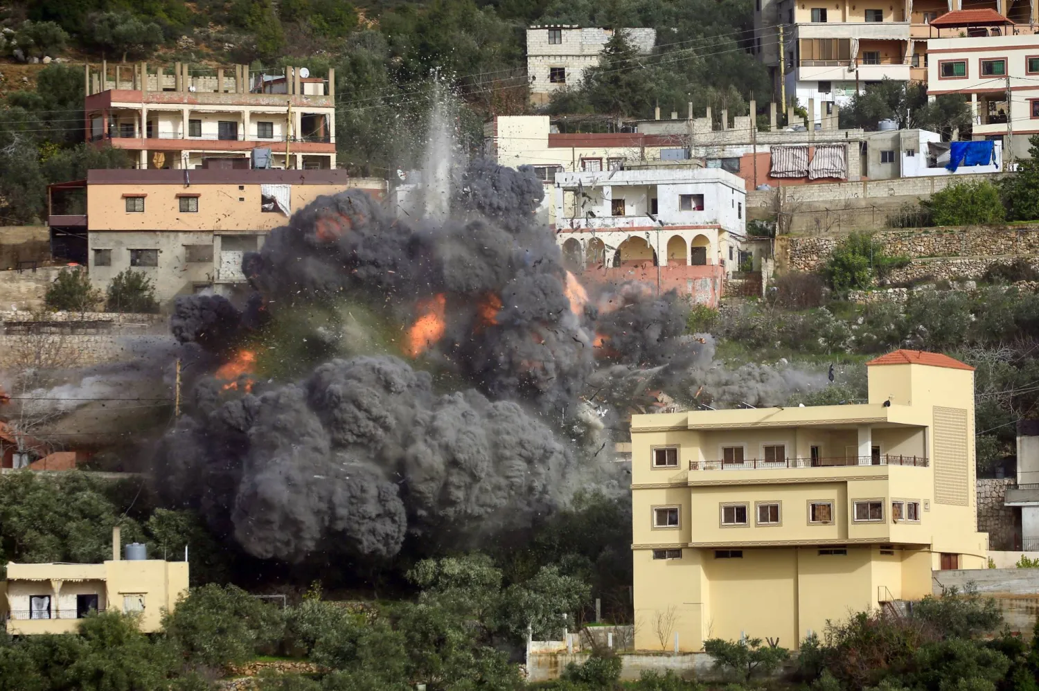 Smoke and flames rise from a building after an Israeli airstrike in Ain Qana village, in southern Lebanon, 02 February 2026. (EPA)